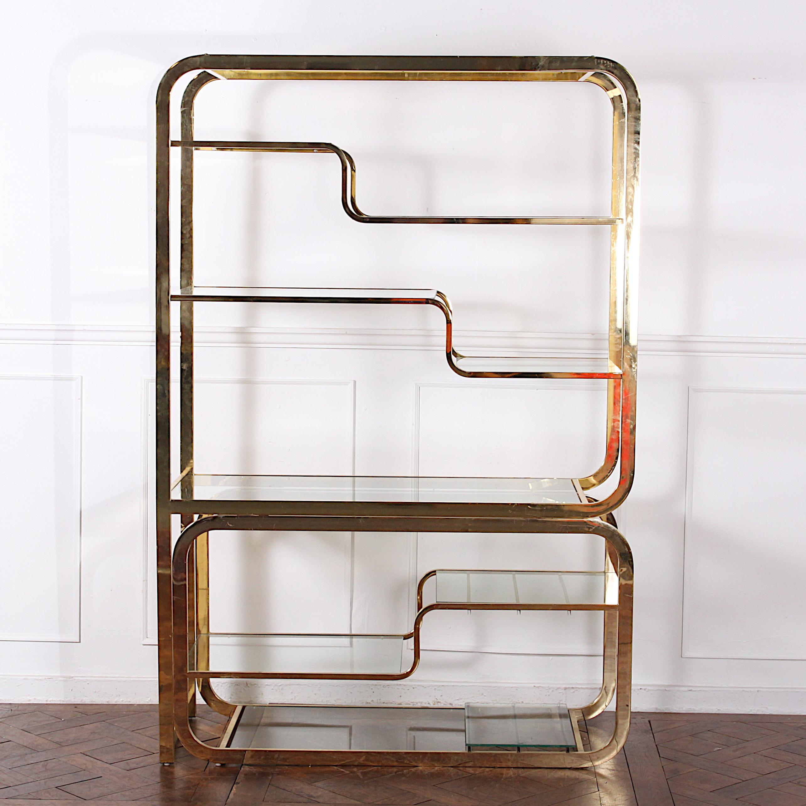 Brass and glass adjustable etagere, with a width of between 48? and 80?.
Impressive Mid-Century Modern brass and glass etagere with great modular design attributed to Milo Baughman. This etagere features a innovative cantilever base that can moved