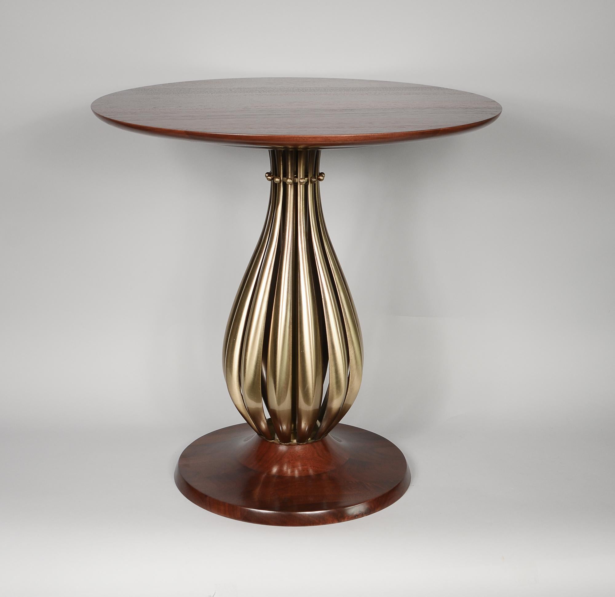 Side table in brass and walnut by the Rembrandt Lamp Company. This has an onion shaped ribbed brass center with solid walnut base and top. This was offered as a floor lamp as well. The lamp pole extended up through the top in that version. The