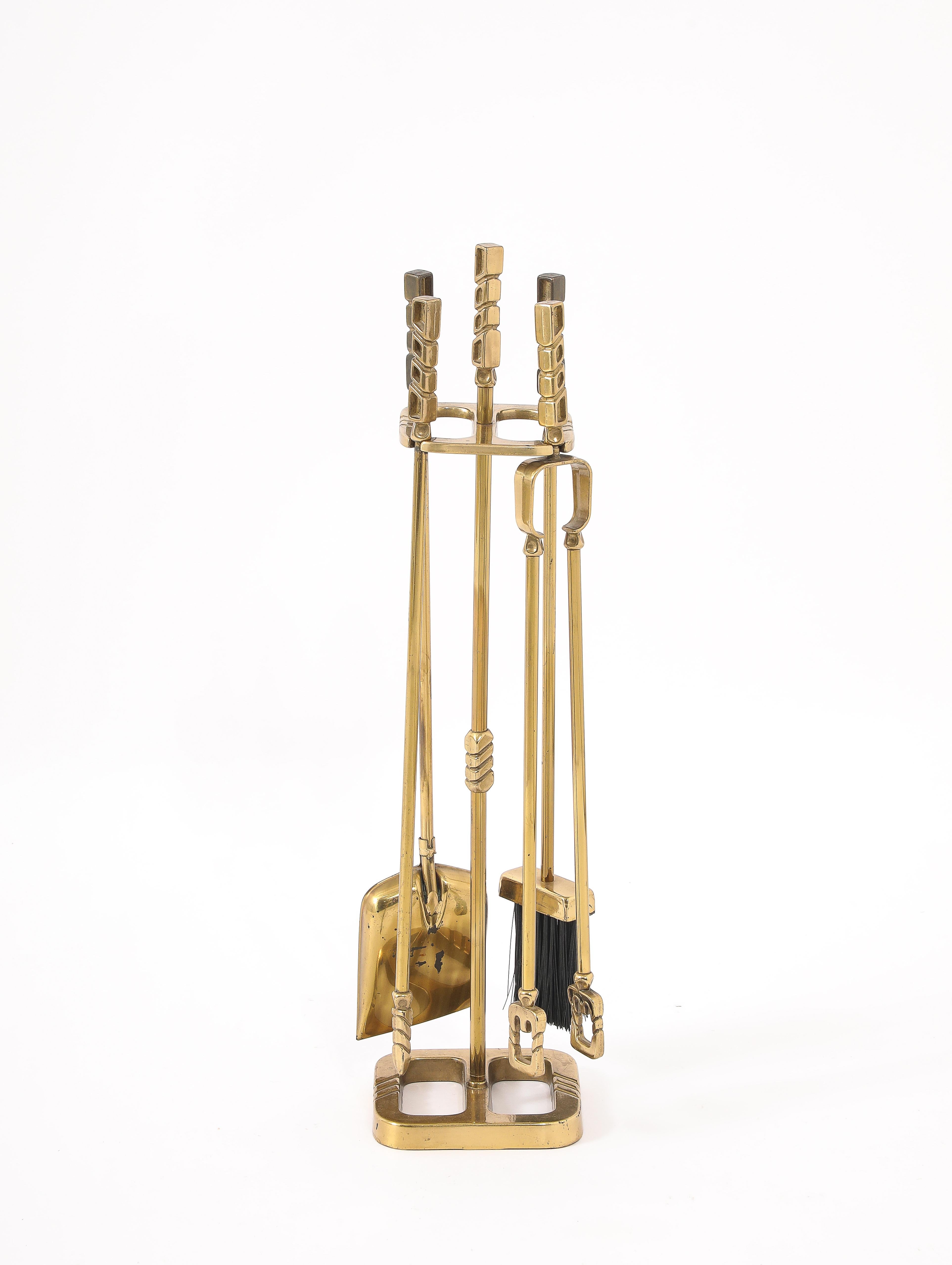 Unusual set of matched andirons, screen and tools with grooved details.