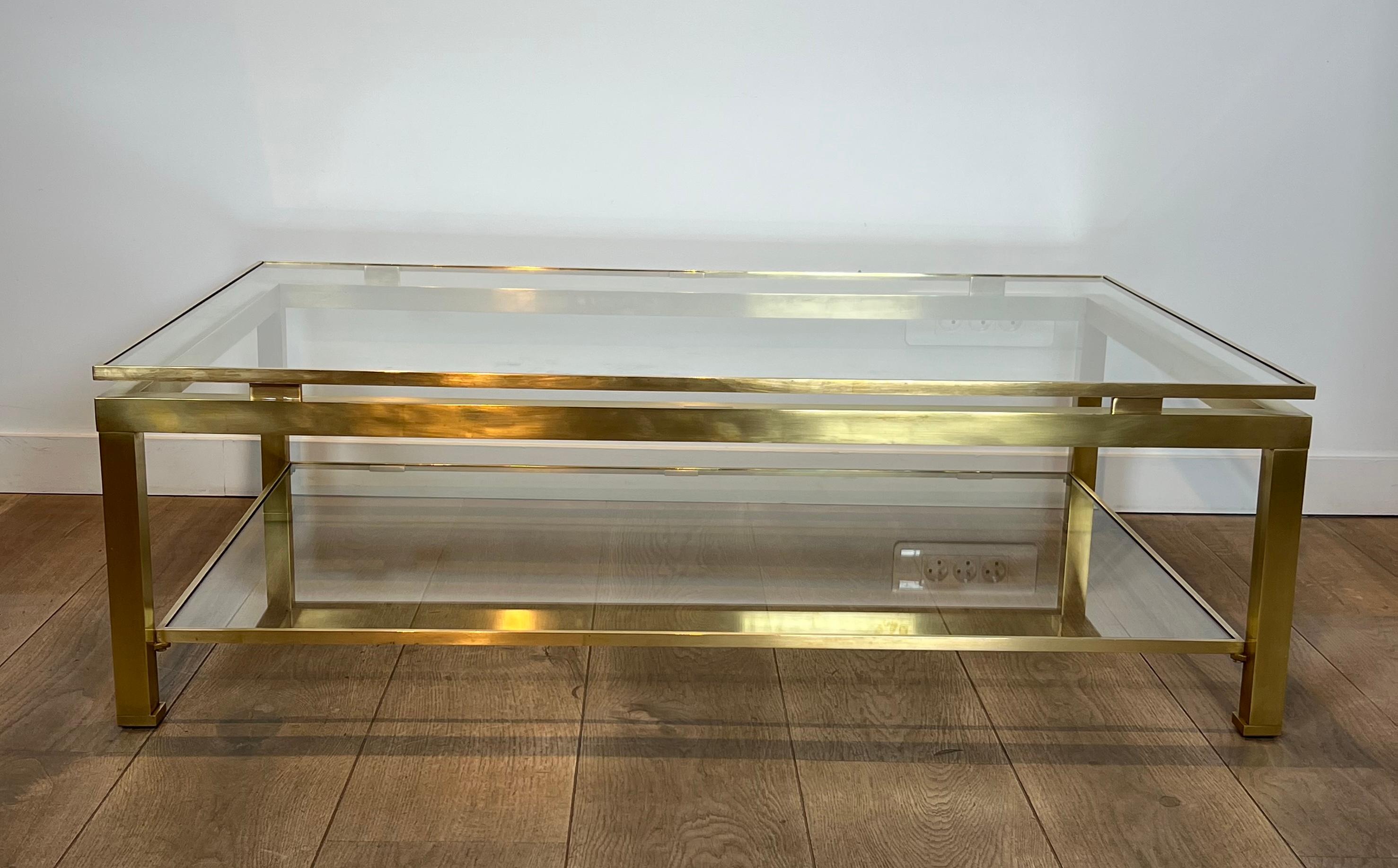 This very nice and rare large modernist coffee table is all made of brass with smoked glass shelves. This model is really rare in this size, which let us think this is a probably a private order. The brass had been perfectly polished and smoked