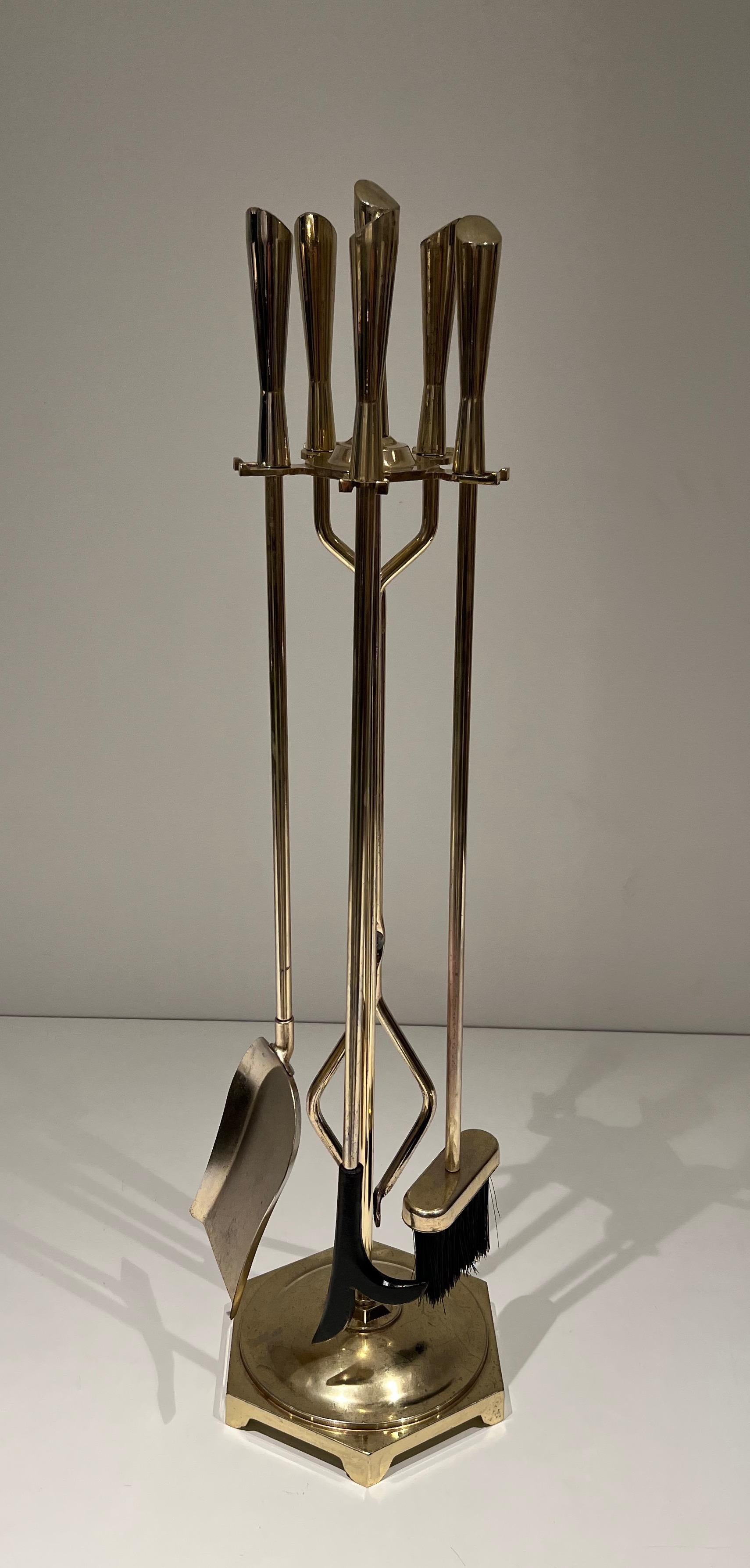 This nice modernist fireplace tools is made of brass . This is a French work. Circa 1970