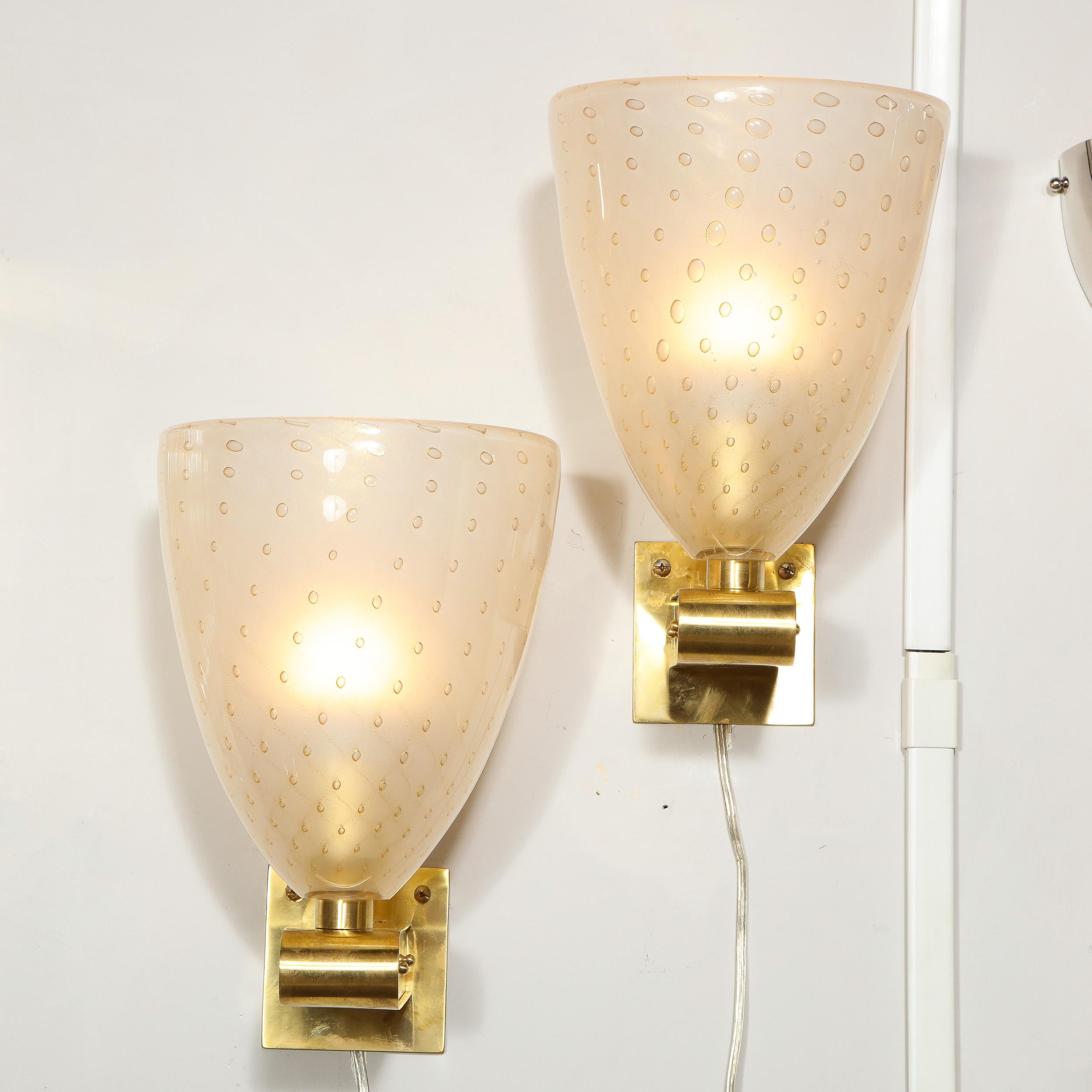 This gorgeous pair of sconces were hand blown in Murano, Italy- the islands off the coast of Venice renowned for centuries for their superlative glass production. They are composed of billowing semi-translucent glass shades with a subtle iridescent