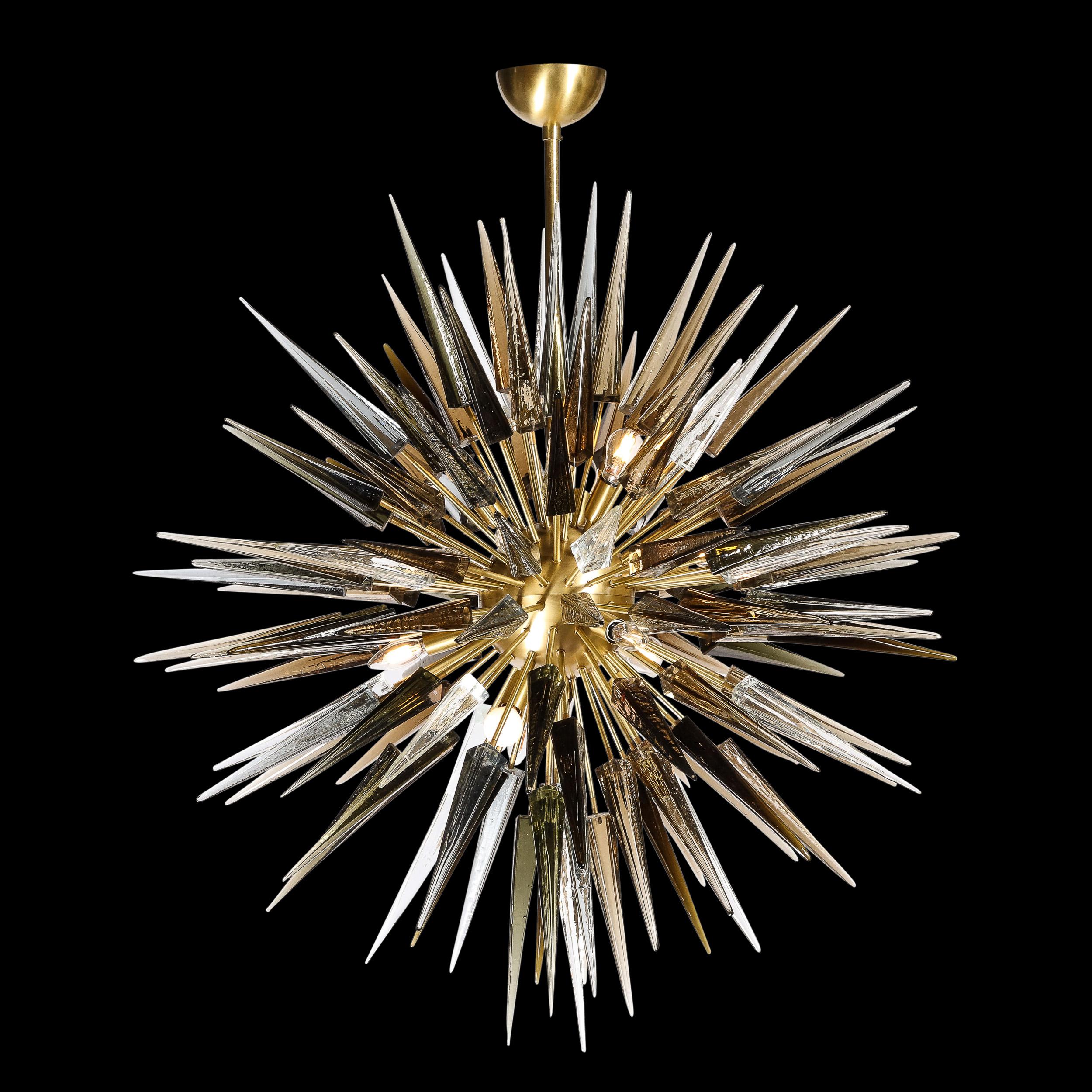 This stunning and graphic modernist chandelier was realized in Murano, Italy- the islands off the coast of Venice renowned for centuries for their superlative quality glass. It features an abundance of handblown Murano glass obelisks in translucent,