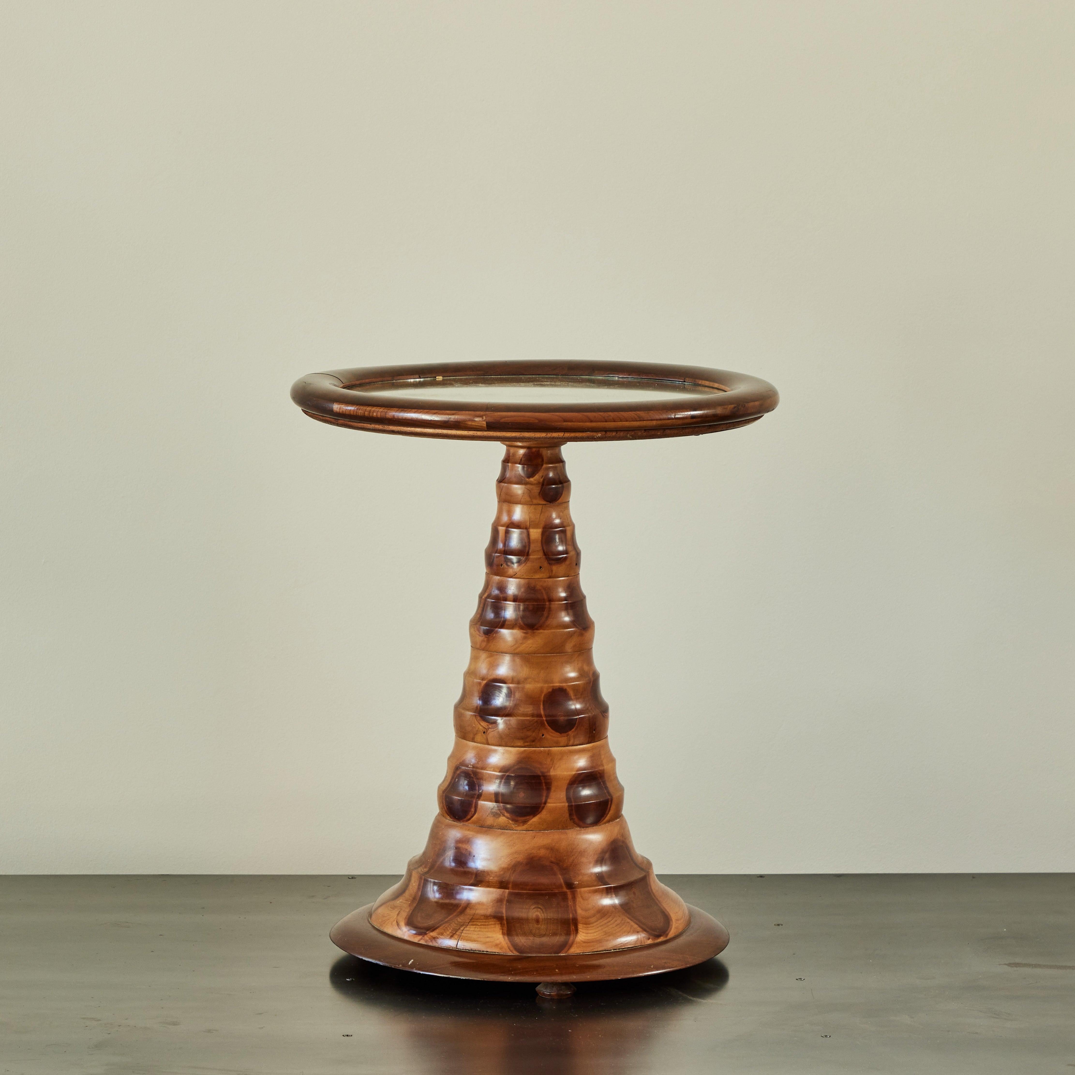 1930s Brazilian side or occasional table in exotic Araucaria Araucana wood, otherwise known as Monkey Puzzle Wood. With a circular mirrored top and lightly beveled rings accentuating the winged conical base, the piece has a sleek, yet organic