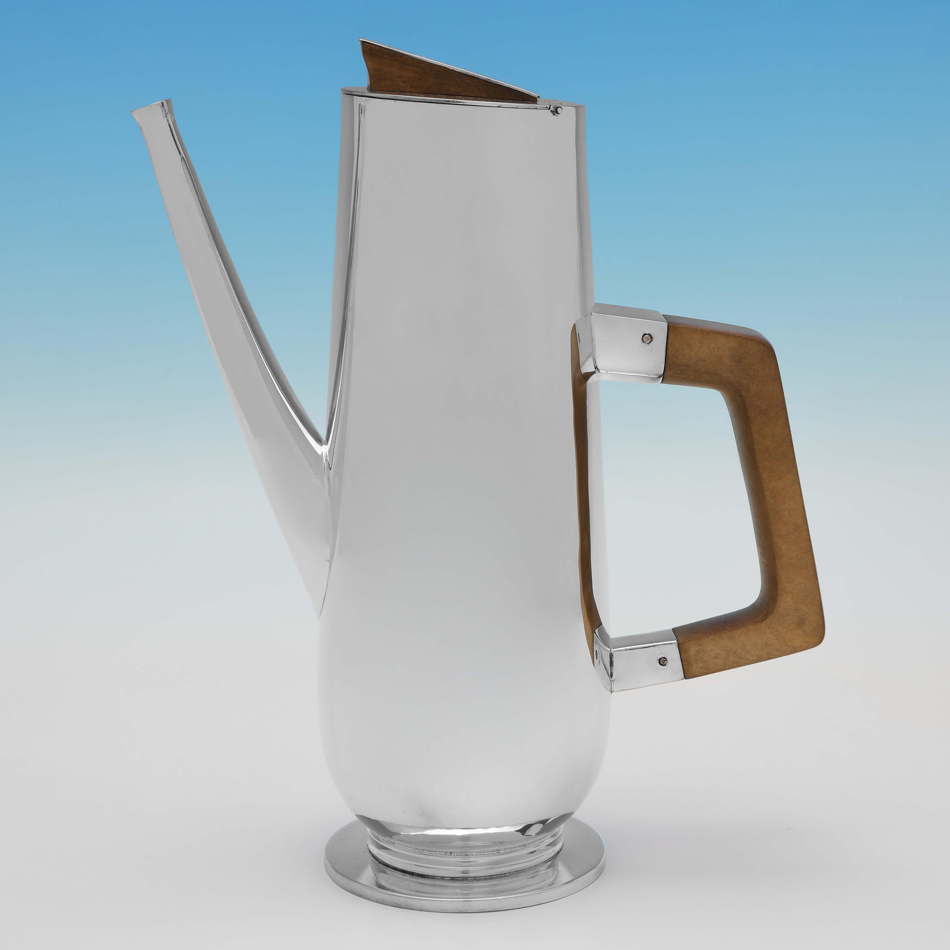 Hallmarked in Birmingham in 1967 & 1974 by H. Brown, this very stylish and handsome, Britannia Standard Silver Cafe Au Lait, is of a strikingly modern design, with one pot having an ebonised handle and finial, and one having a lighter wooden handle