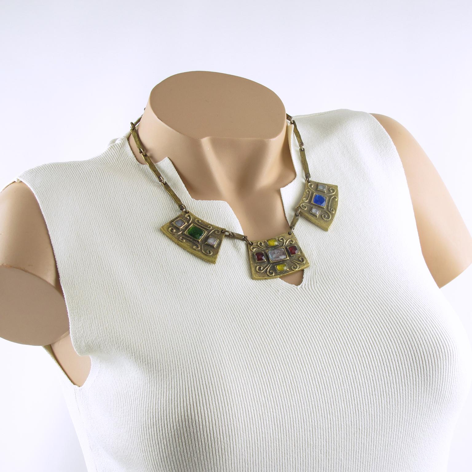 This charming modernist bronze choker necklace boasts a geometric construction with three central medallions on a heavy gilded bronze worked chain. Each geometric bronze medallion is embellished with poured glass cabochons in white opalescent,