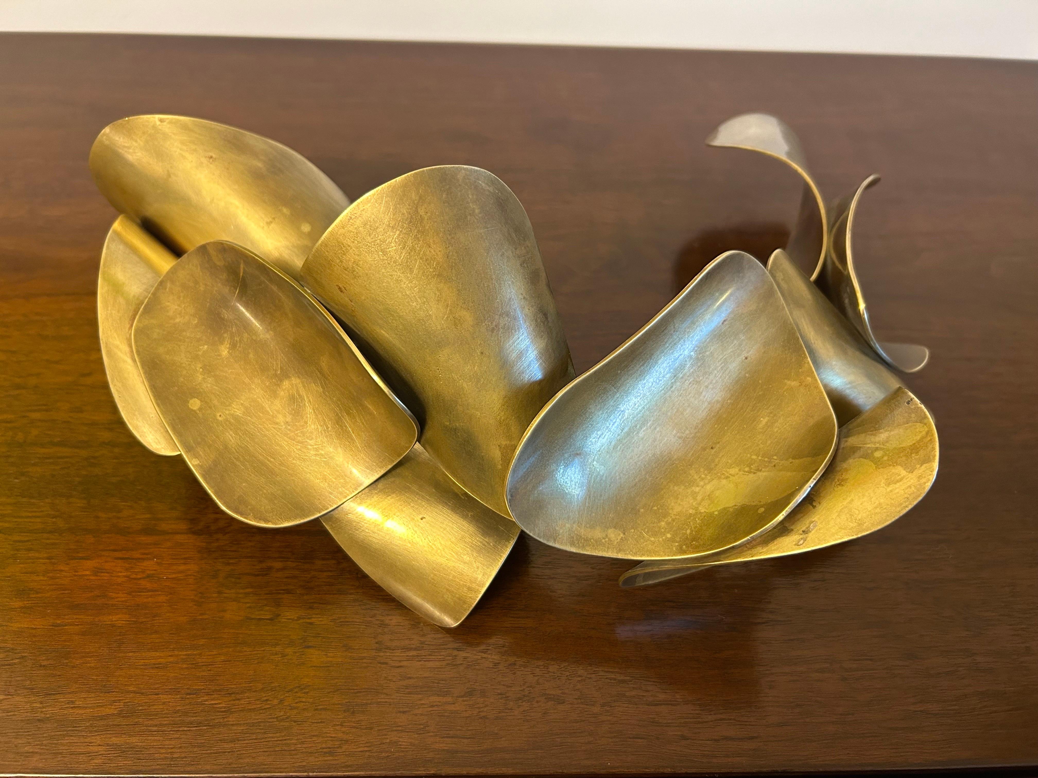 Nice form with undulating thin wedges. 
It does not appear to have a front or back and can be displayed in any way one chooses. 
Great as a decorative art object on a credenza or pedestal.
Nice patina.
No damage. 
Great condition.
Presents