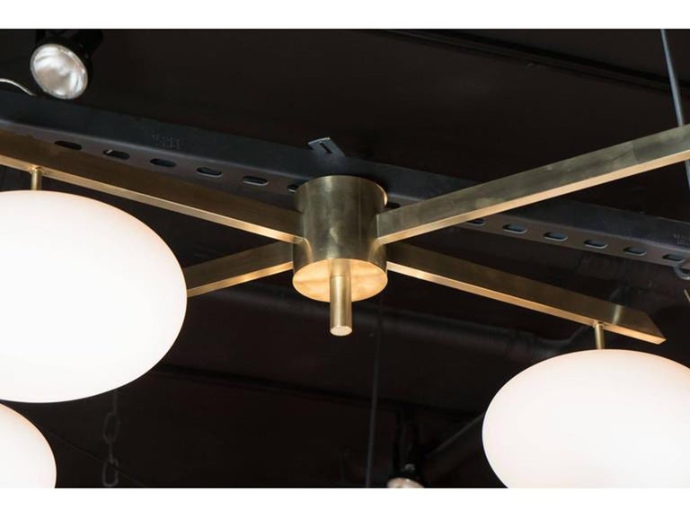 Contemporary Modernist Brushed Brass & Frosted Glass 4-Arm Globe Chandelier For Sale