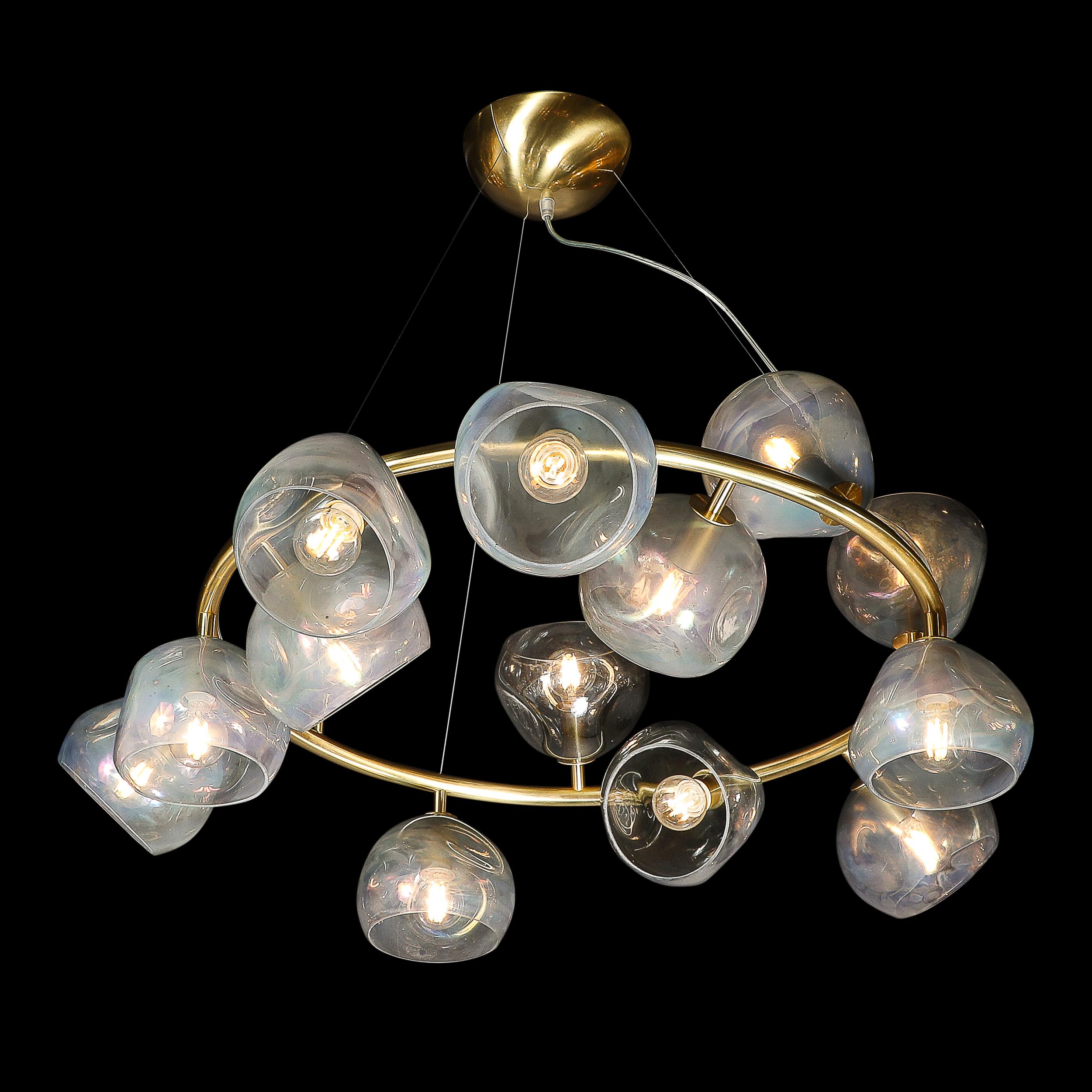 This unique and elegant Modernist Brushed Brass & Smoked Organic Hand-Blown Murano Glass Chandelier originates from Itay during the 21st Century. This Chandelier features an array of hand-blown opalescent shades with beautiful detailing and organic