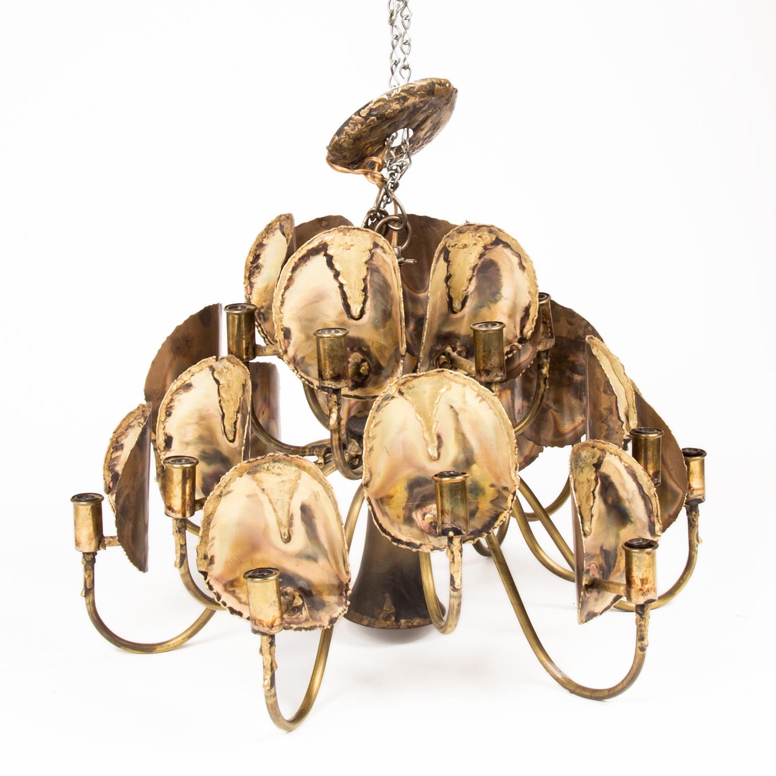 Modernist Brutalist torch-cut chandelier/pendant by Tom Greene for Feldman Company, circa 1970s. 18 lights, one down light. Hang chain and cover plate are present. Presently in working order. 1 bulb base has a split, but does not affect look or