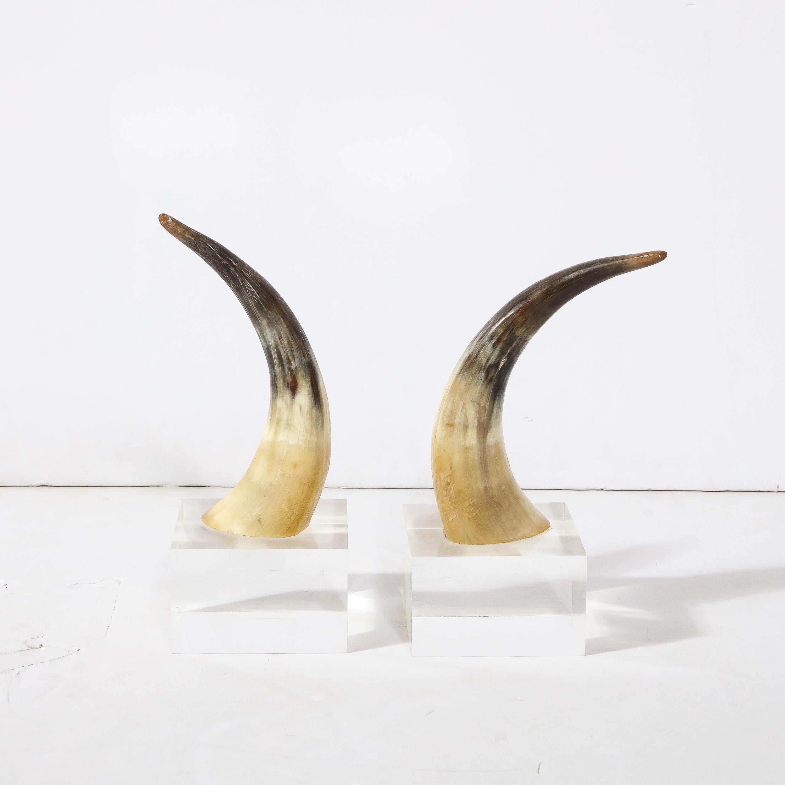 This stunning pair of modernist bull horn book ends were realized in the United States during the latter half of the 20th century. They offer the curved bull horns with their innately dynamic form and gradient color palate transitioning from a dark