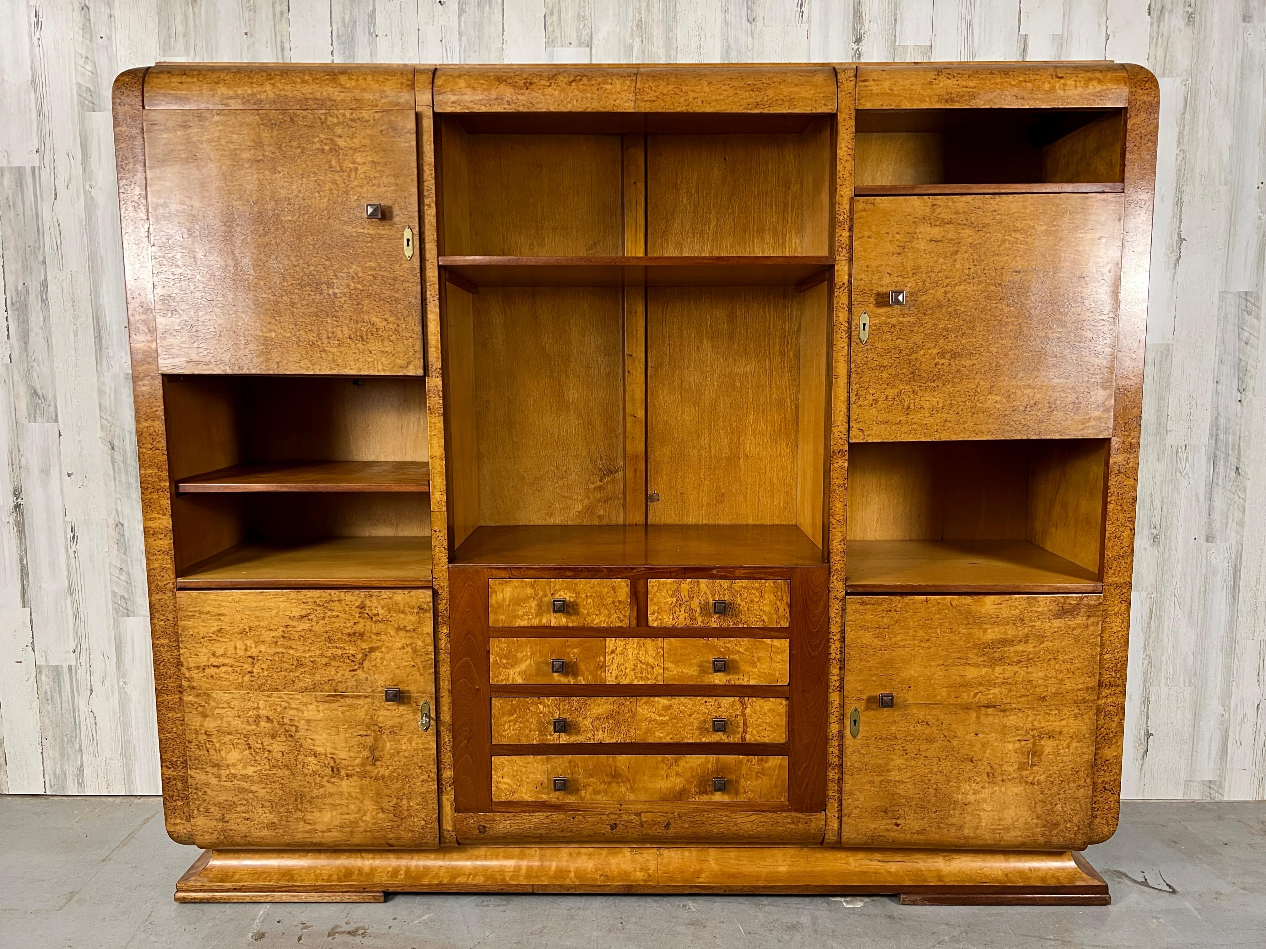 Birdseye maple waterfall cabinet /bookcase with multiple enclosed cabinets and open shelves. This cabinet does disassemble for easy transport.
The bottom doors have working locks, the upper doors the locks do not work but the have been fitted with