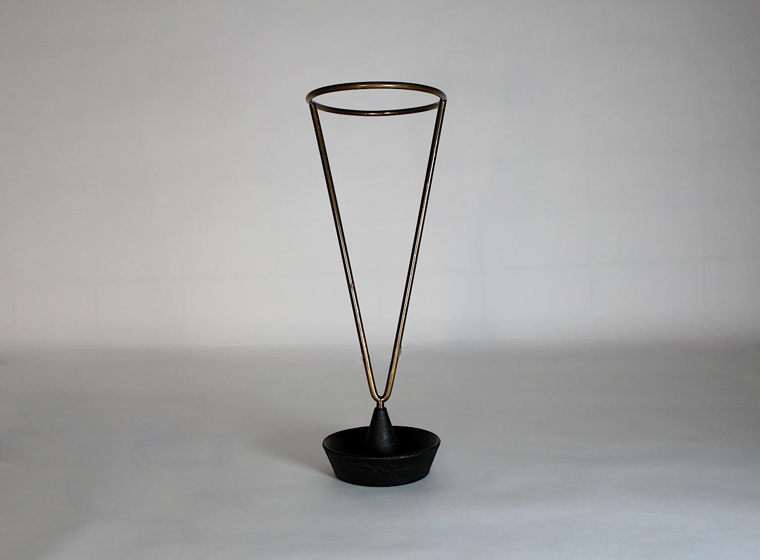 Modernist vintage authentic umbrella stand or cane holder from brass and black iron by Carl Auböck for Werkstätte Auböck 1950s Austria.
An iconic umbrella stand model number 4293 by Carl Auböck from the 1950s
with beautiful desirable brass patina,
