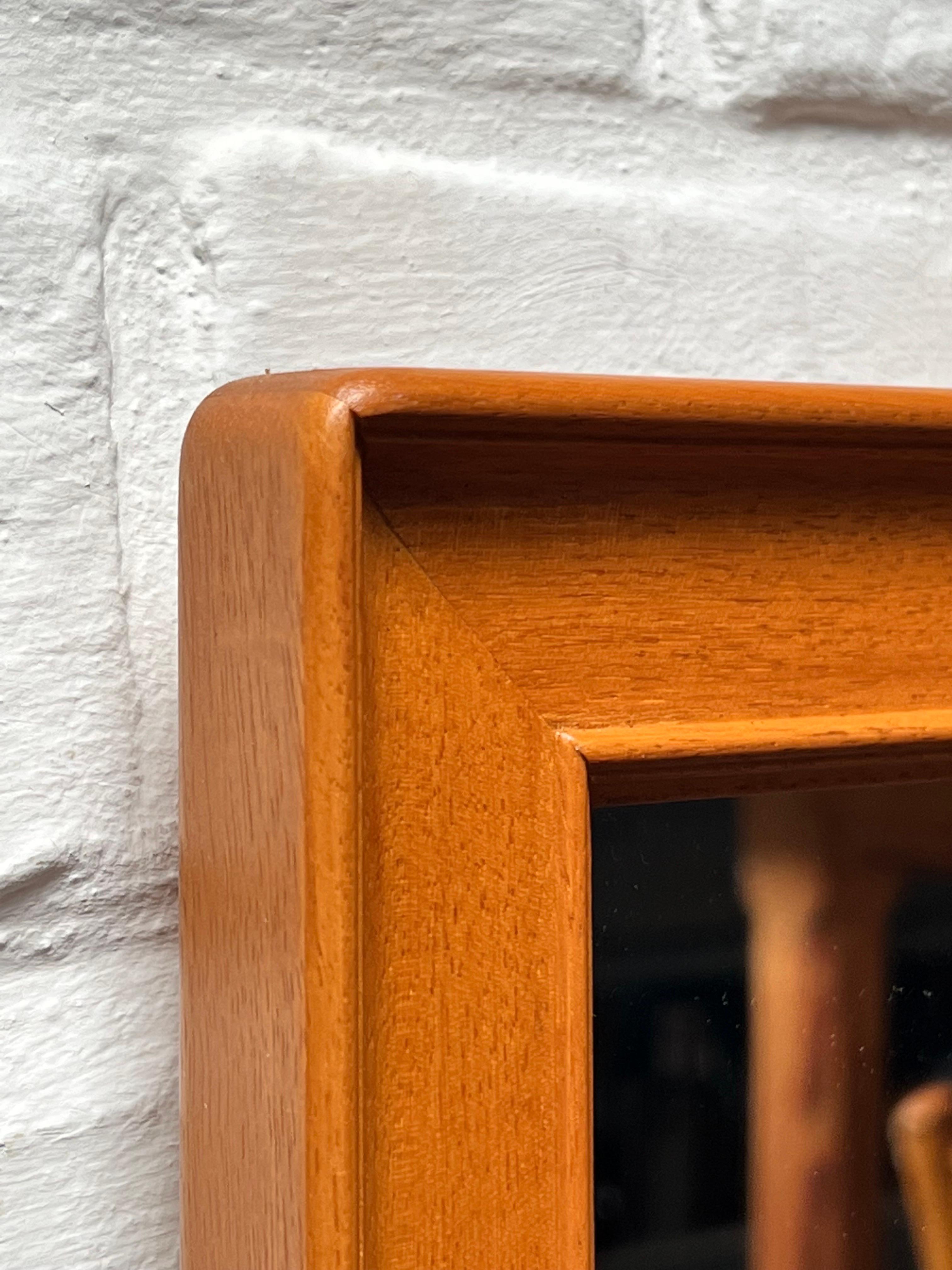 This is an unusual Mahogany mirror produced in Sweden in 1994 by one of the craftsman students of the Malmsten school. Elegant and classic shape. It will brighten any projects. We just cleaned it and there's minor traces of use. Branded with Carl