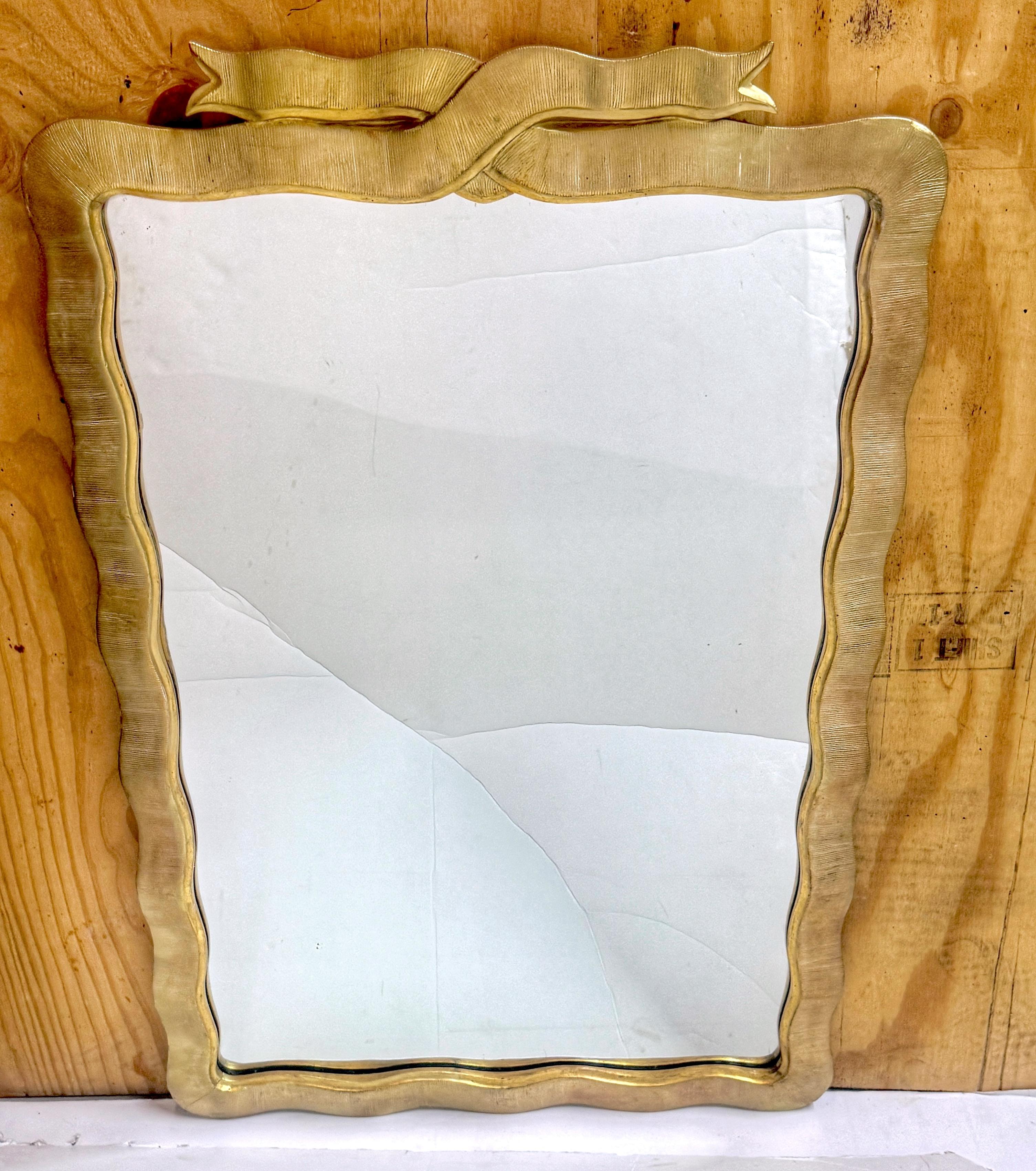 Modernist Carved Giltwood Ribbon Motif Mirror, American, 1950s

An elegant and sculptural midcentury wall mirror featuring a hand-carved giltwood frame with a flowing ribbon motif. This American-made piece from the 1950s embodies a refined modernist