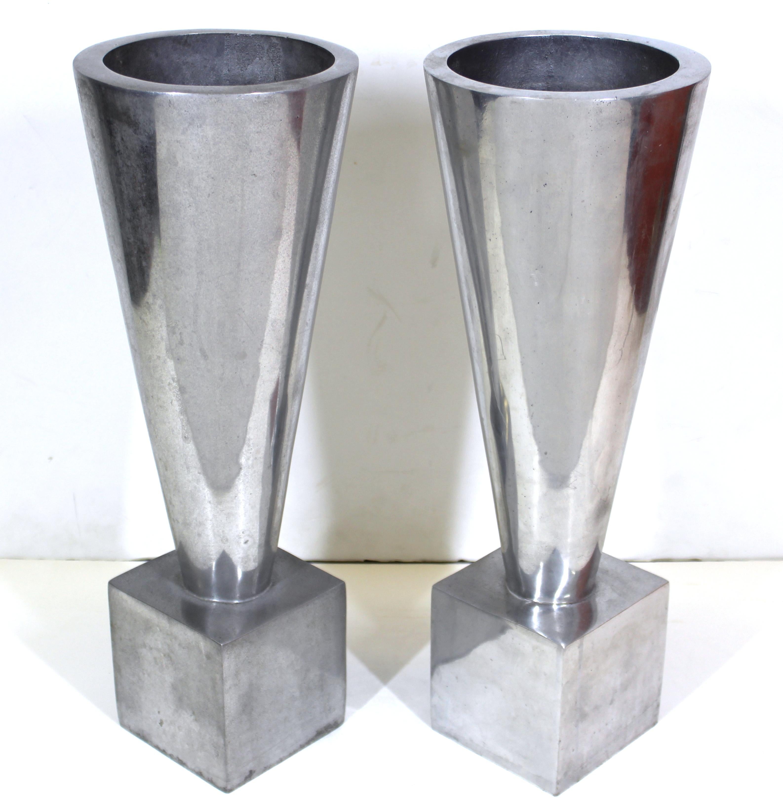 Modernist pair of heavy cast aluminum urns in conical shape on cube footing, made by AZ Cast Products. Makers mark stamped on to the bottom. The pair was made during the 1970s in the United States and is in great vintage condition with