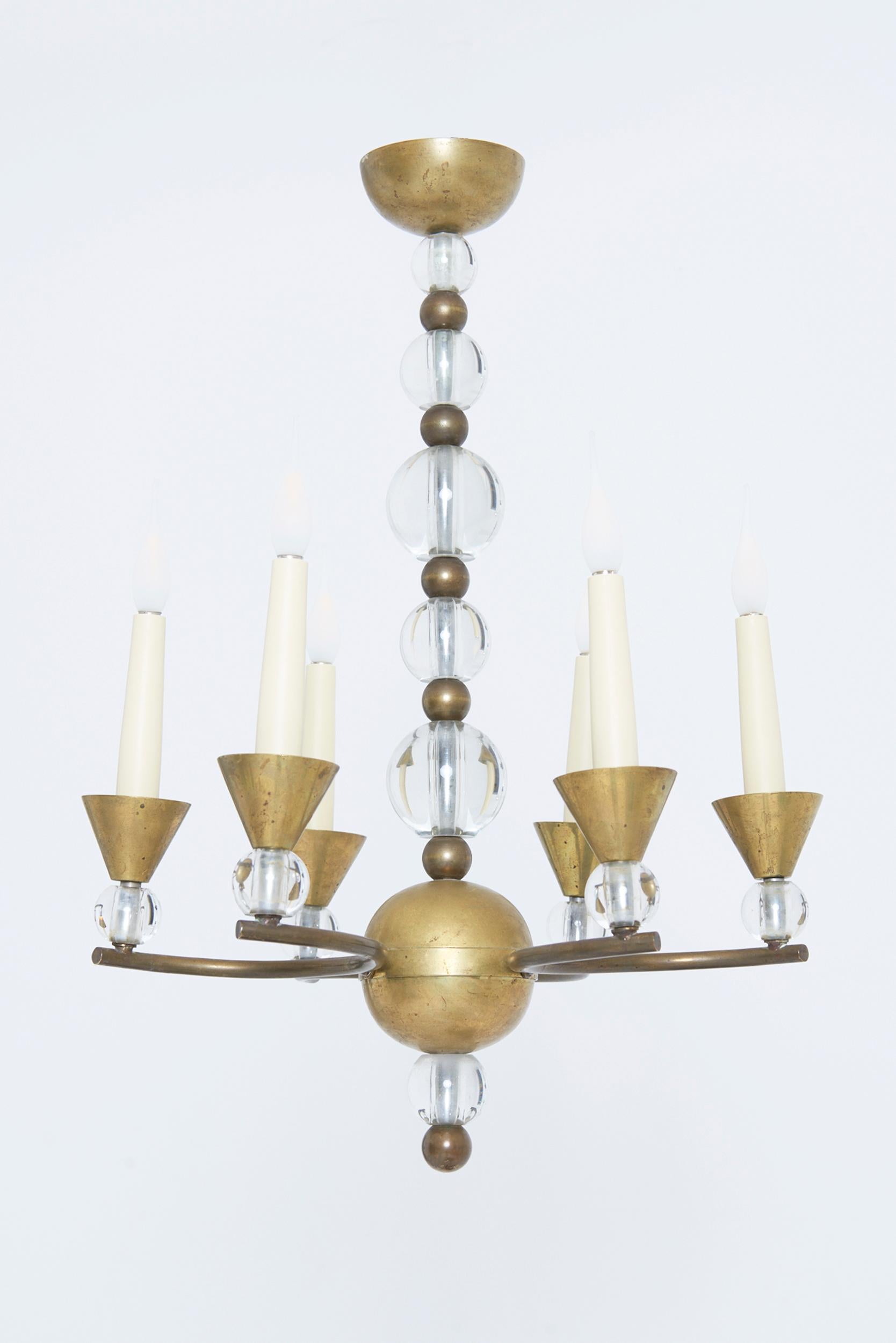 A Modernist brass and solid glass ceiling light by Jacques Adnet (1900-1984)
France, Circa 1930
