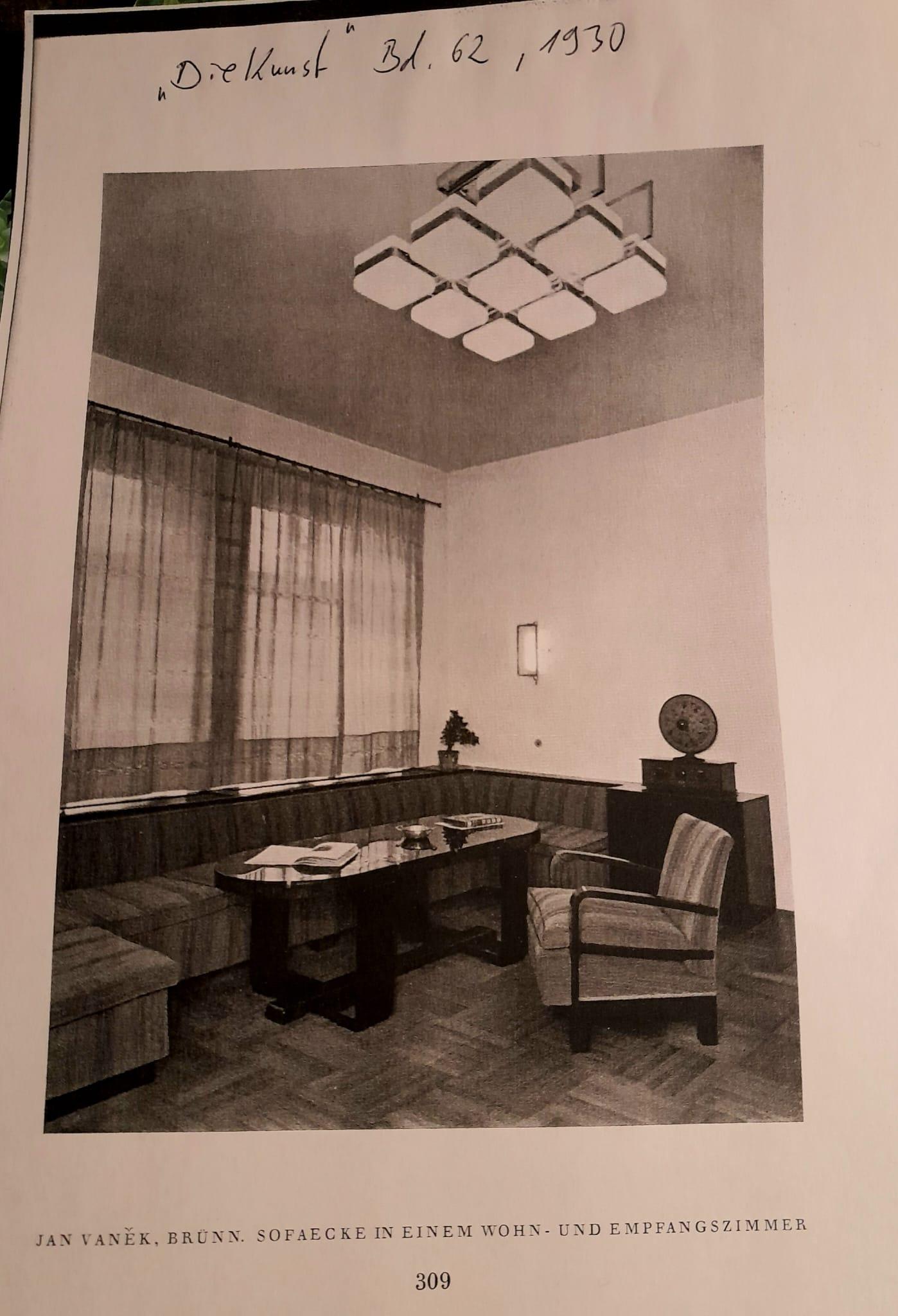 Large ceiling lamp made of nickel-plated steel with eight lamps with frosted glass shades in a square shape. The lamp is illustrated in 