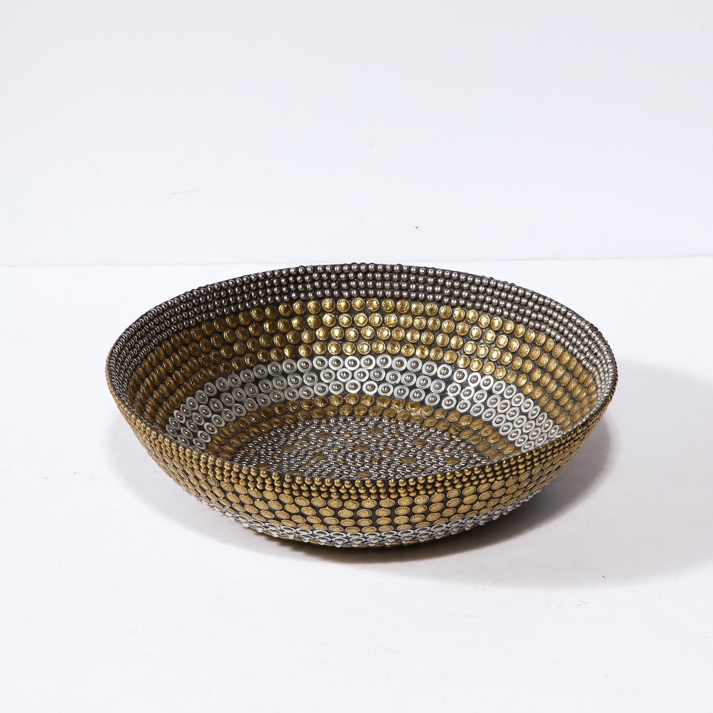 This refined and sophisticated modernist center piece bowl was realized by the esteemed designer Kim Seybert in the Philippines during the latter half of the 20th century. The exterior of the piece is laden with an abundance of brass and nickel