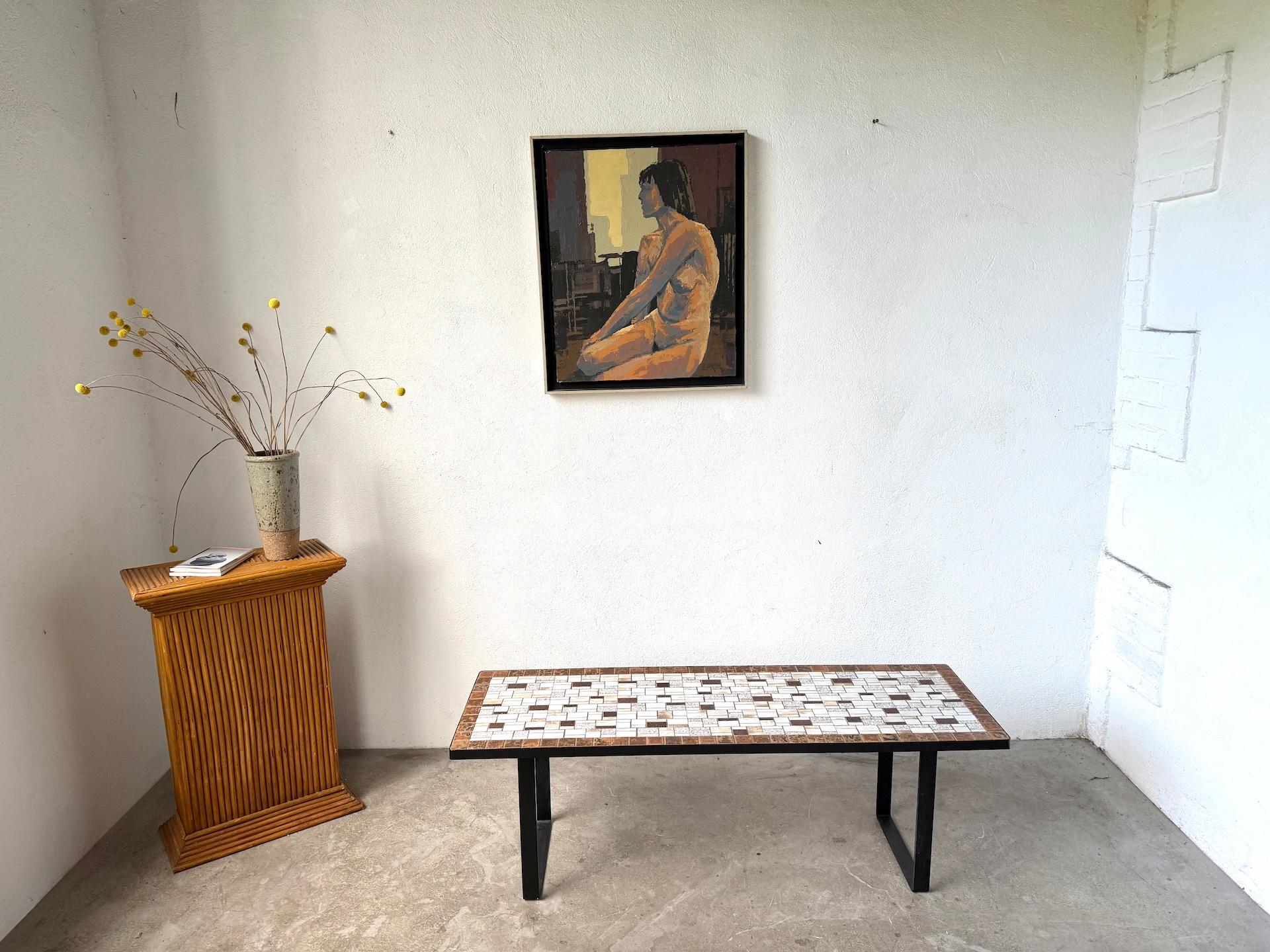 Maison Lecan presents Modernist ceramic coffee table, circa 1960

Rectangular coffee table featuring a mosaic top composed of glazed ceramic tiles in brown, white, and golden tones arranged in a striking geometric pattern. The contrast of matte and