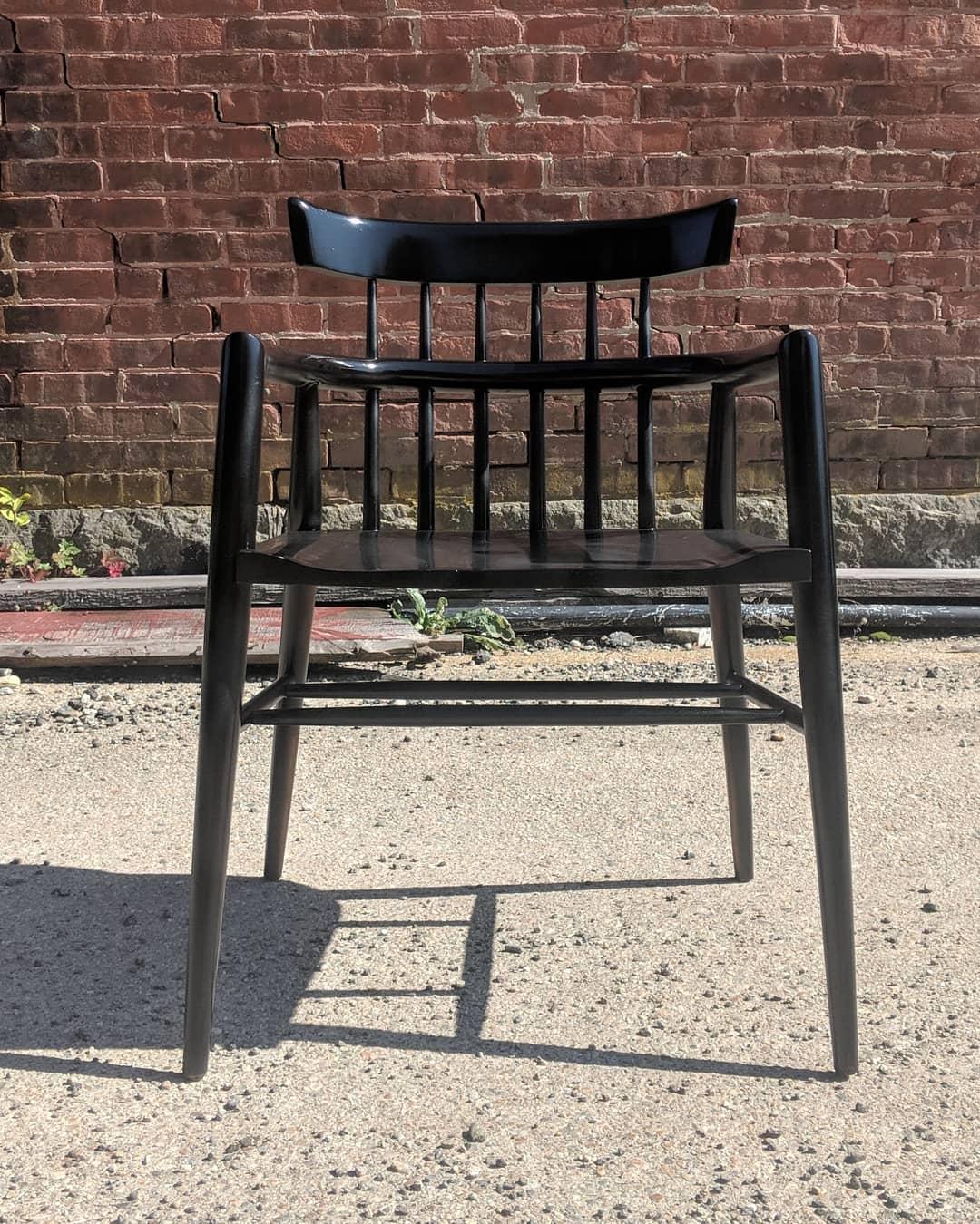 Modernist comb-back windsor chair in black lacquer, designed by Paul McCobb, circa 1955.  Arm height is 25 1/4