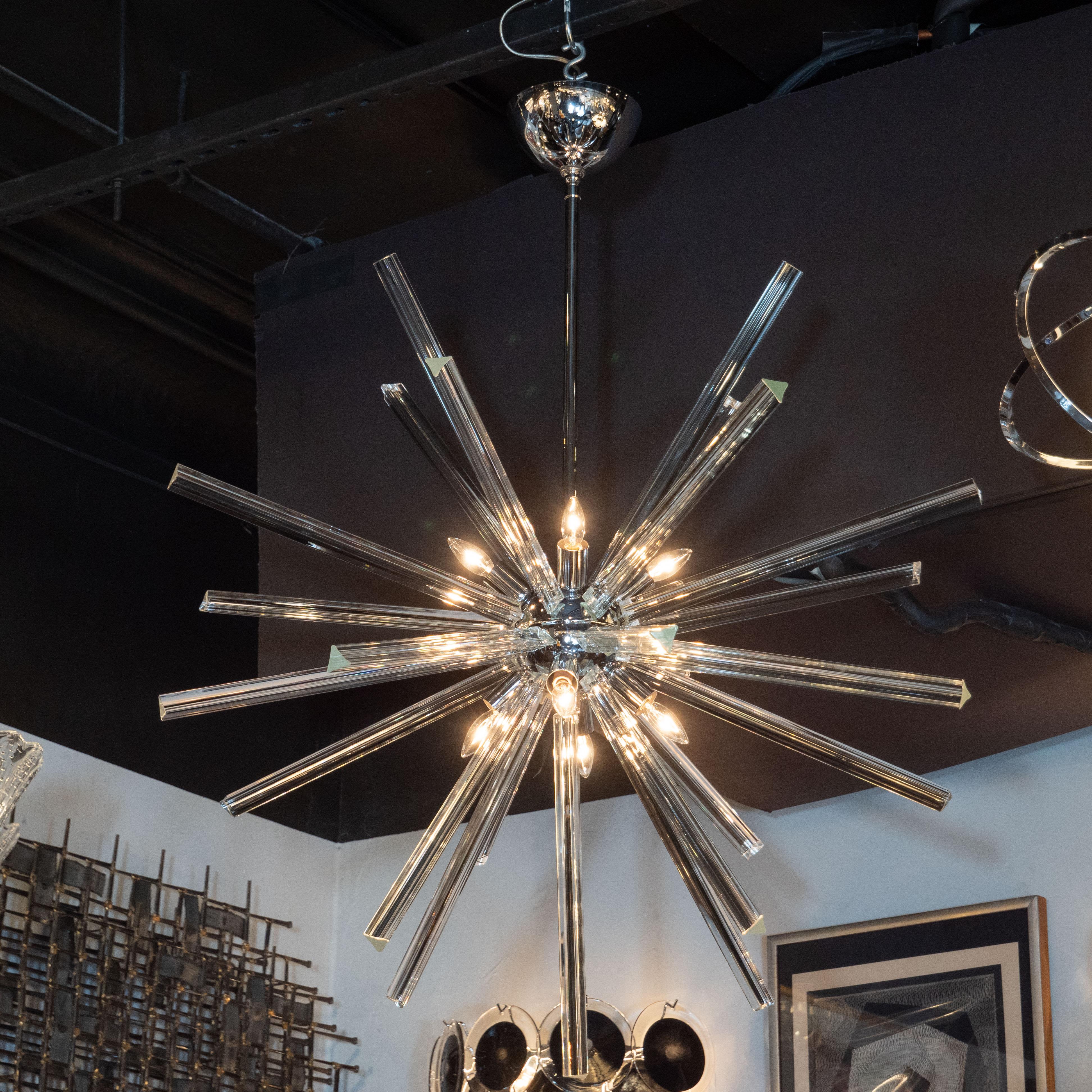 This elegant and graphic Sputnik chandelier was hand blown in Murano, Italy- the island off the coast of Venice renowned for centuries for its superlative glass production. It features a spherical central orb with an abundance of translucent hand