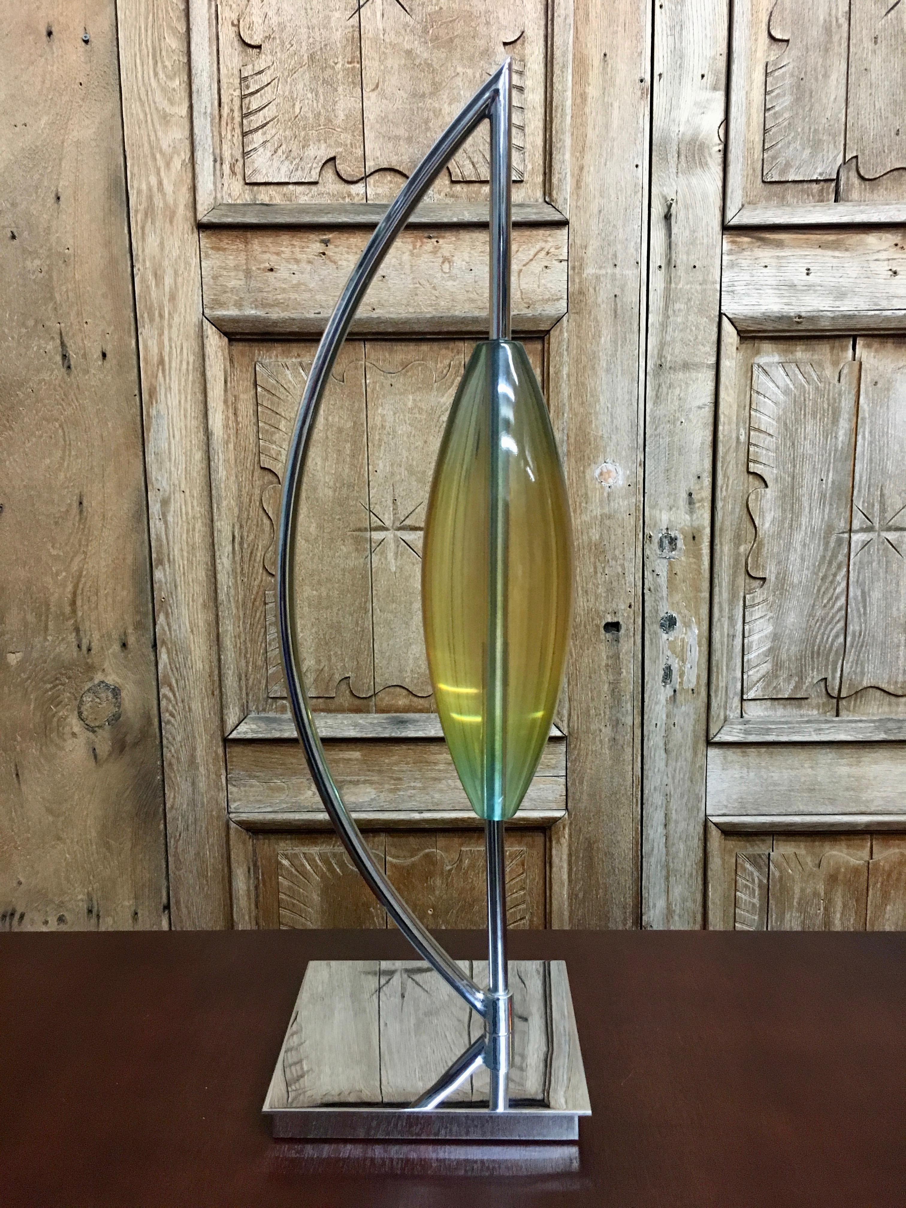 Modernist chrome and Lucite free standing sculpture. Eye-catching yellow, red, and light green shades.