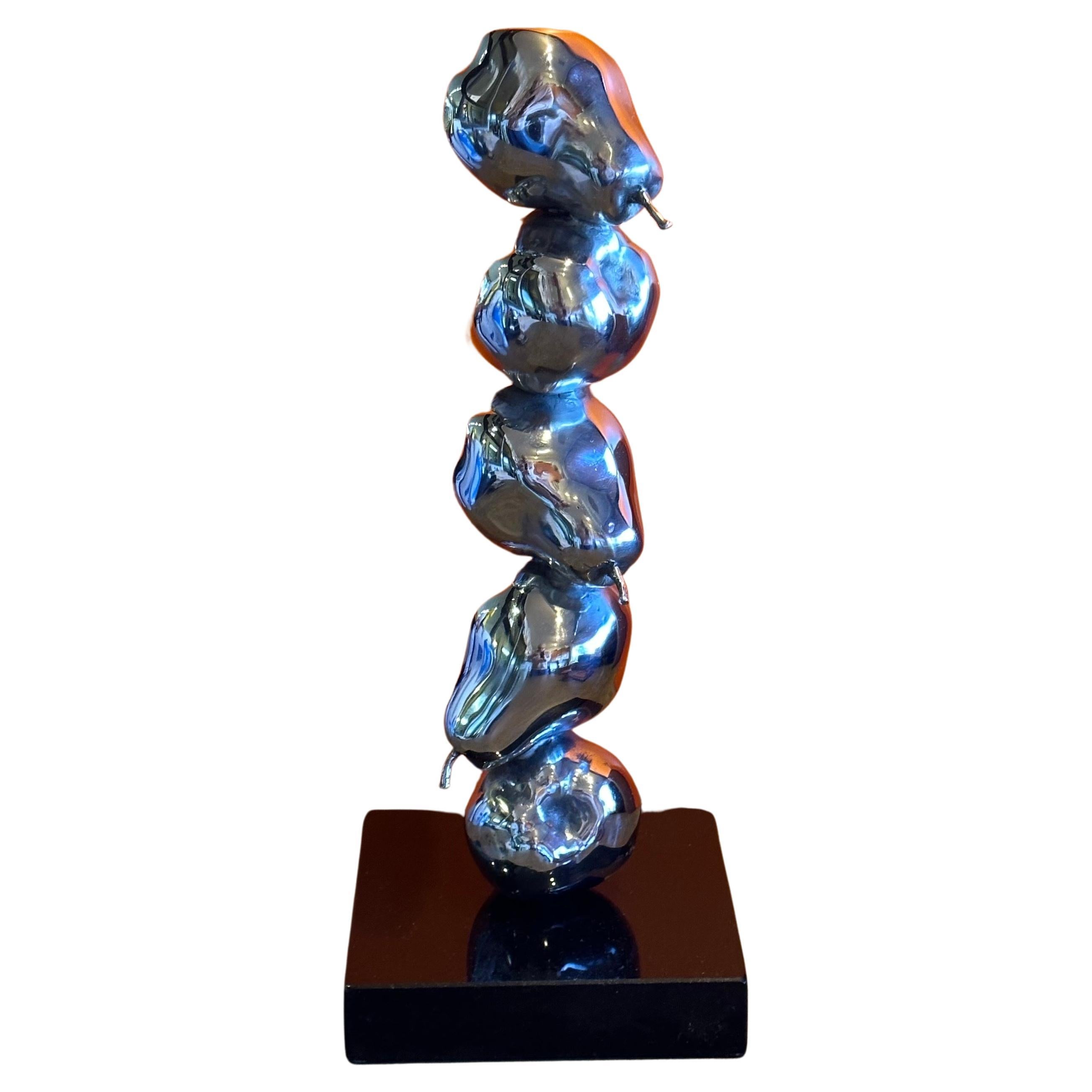 Modernist chrome on black marble stacked pears sculpture, circa 1980s. 
The piece is very well crafted and in excellent vintage condition with no chips or cracks; it measures 6