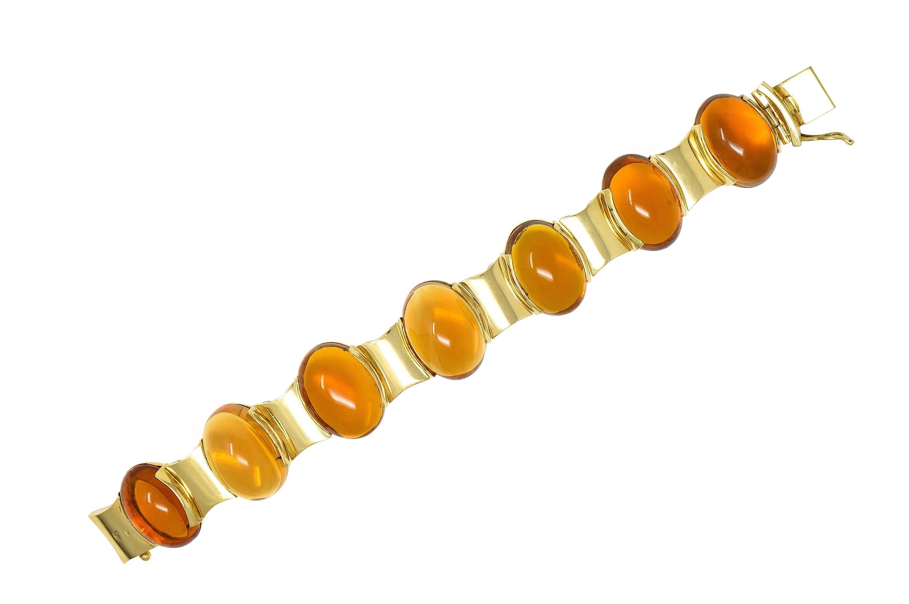 Featuring seven oval-shaped citrine cabochons set in semi-bezel hinged links
Measuring 15.0 x 20.0 mm - transparent medium brownish orange in color 
Alternating with gold geometric curved links 
Completed by concealed clasp closure
With hinged