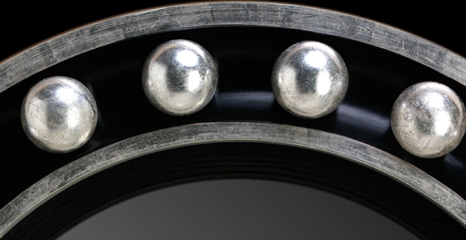 A circular moulded frame in modernist design Neoclassical convex mirror with silver gilt inset circular balls with architectural proportions in an overall ebonised frame. Bespoke sizing, design adaptations and finishing available. Please note that
