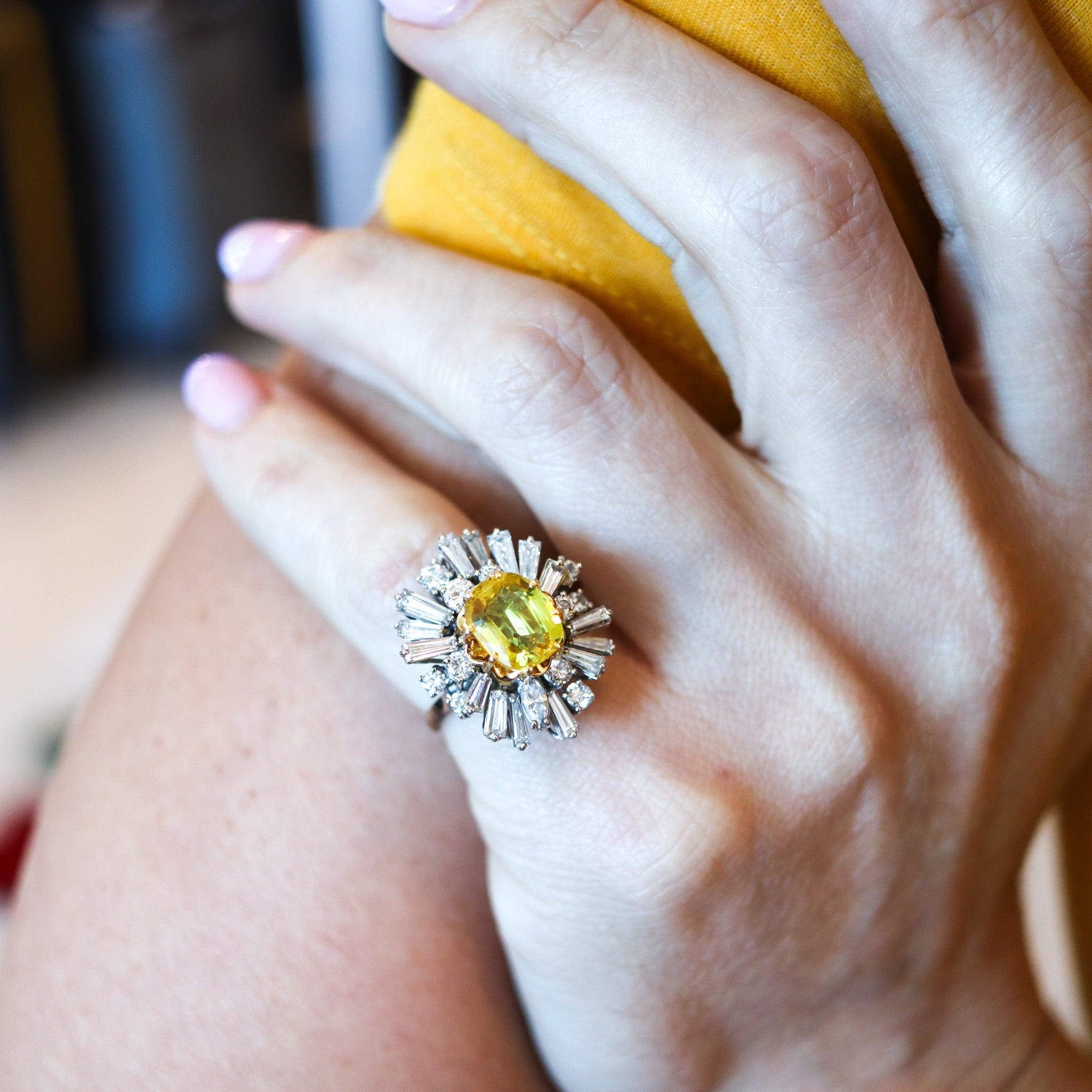A cocktail ring with a vivid yellow sapphire.

This is a beautiful classic cluster cocktail ring, carefully crafted in white and yellow gold of 18 karats with high polished finish. The cocktail ring is embellished with a great assortment of earth
