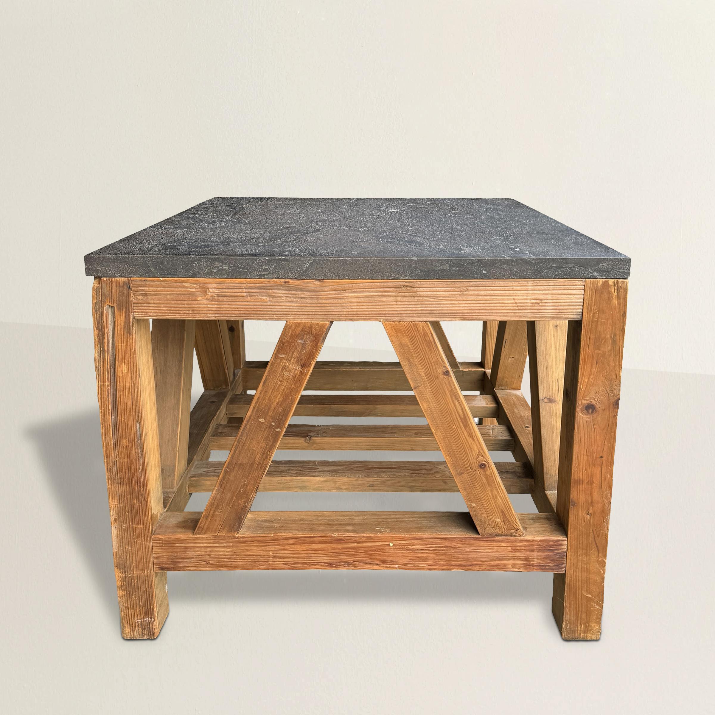 This 20th century American Modernist table, crafted from pine and crowned with a sleek gray marble top, is a captivating fusion of artistic inspiration and functional design. Drawing from the innovative spirit of French sculptor's stands, it pays
