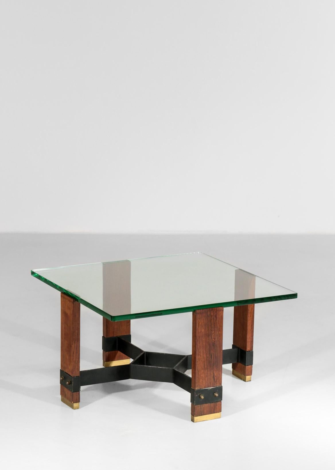 Italian coffee table made of wood, brass and metal for the structure and a thick top in glass.