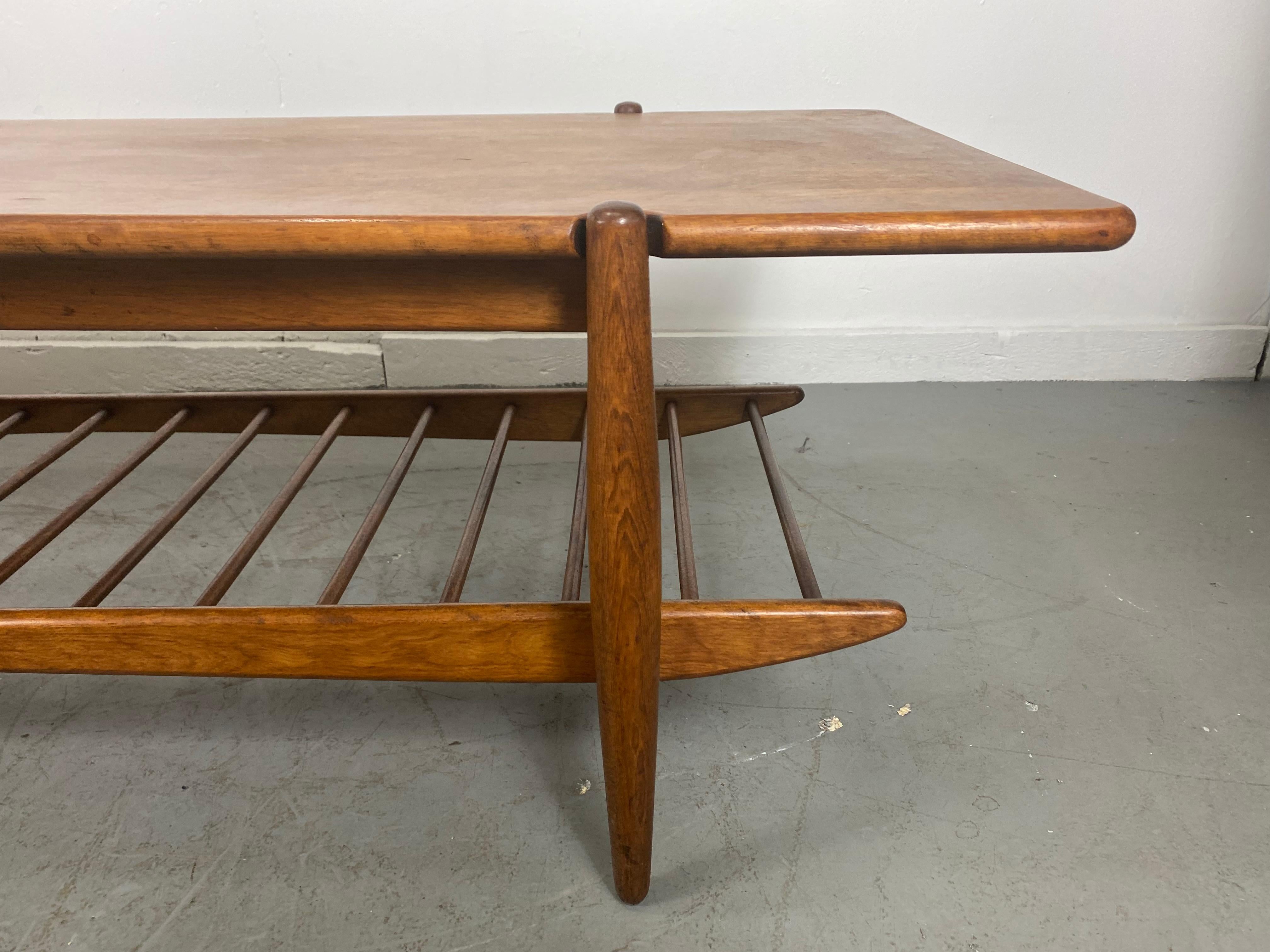 A beautiful Mid-Century Modern coffee table by Leslie Diamond for Conant Ball’s Modernmates line. The perfect length to pair with an extra long sofa. Features , rectangular top, above a unique slatted lower level floating shelf adds additional space