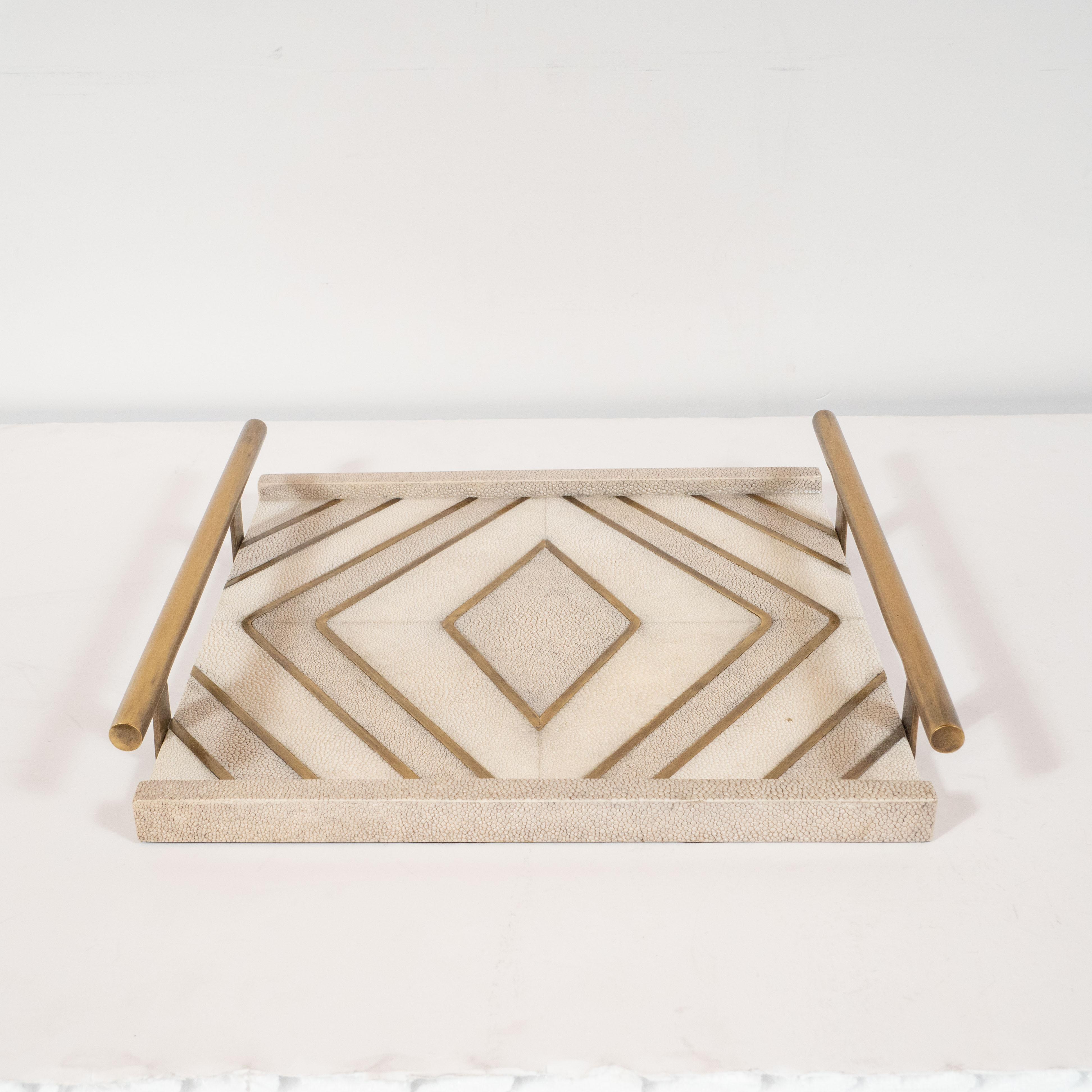 Designed in Paris by the celebrated atelier, Kifu, this refined tray features a wealth of concentric diamond forms embedded into the shagreen body of the tray. It features two raised sides (also in shagreen) and handles composed of rectilinear