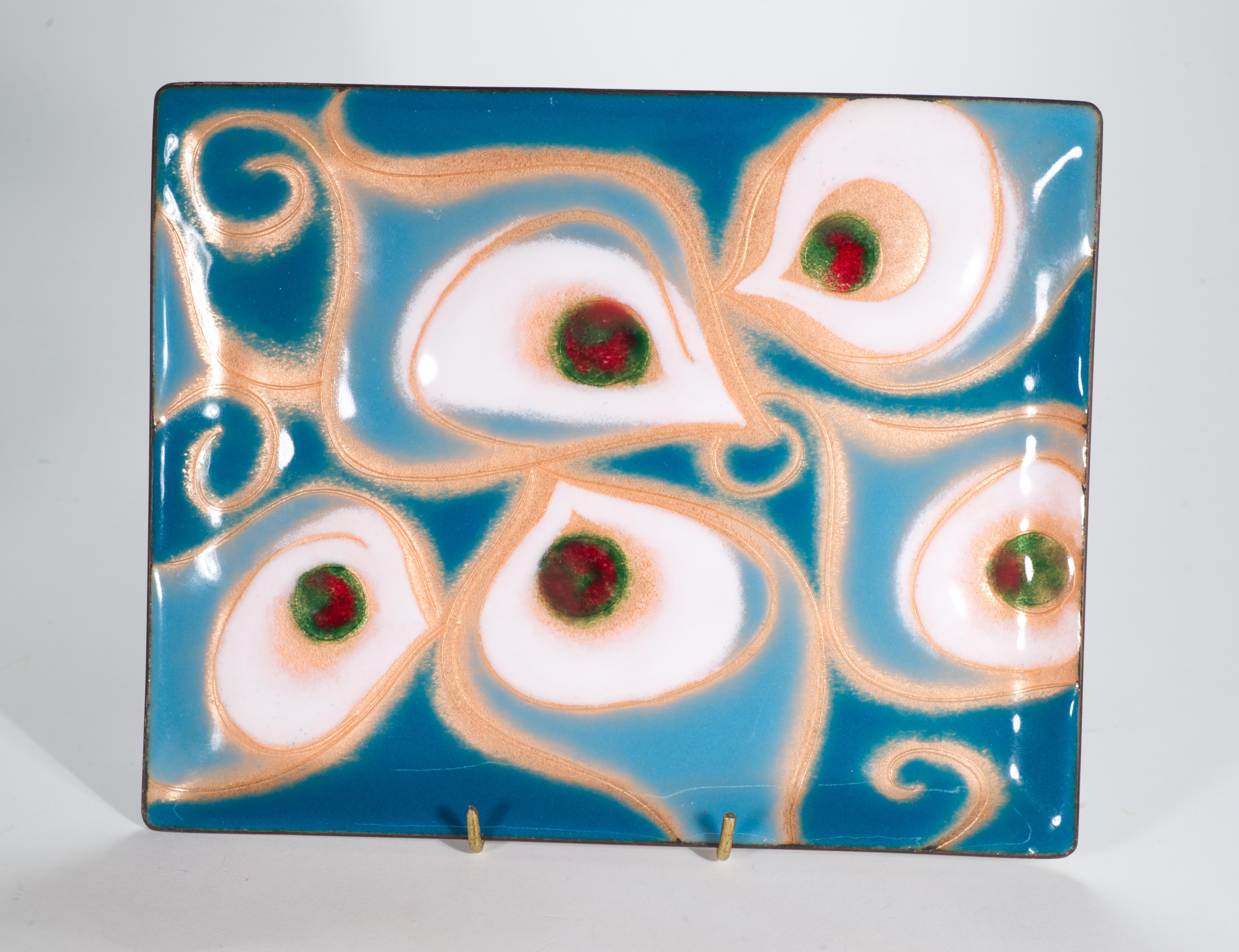  Graphic Modernist rectangular tray or catch-all dish in enameled copper features colorful abstract decor in teal and copper colors with red and green accents. The underside of the tray is enameled in monochromatic black color.

The trays are