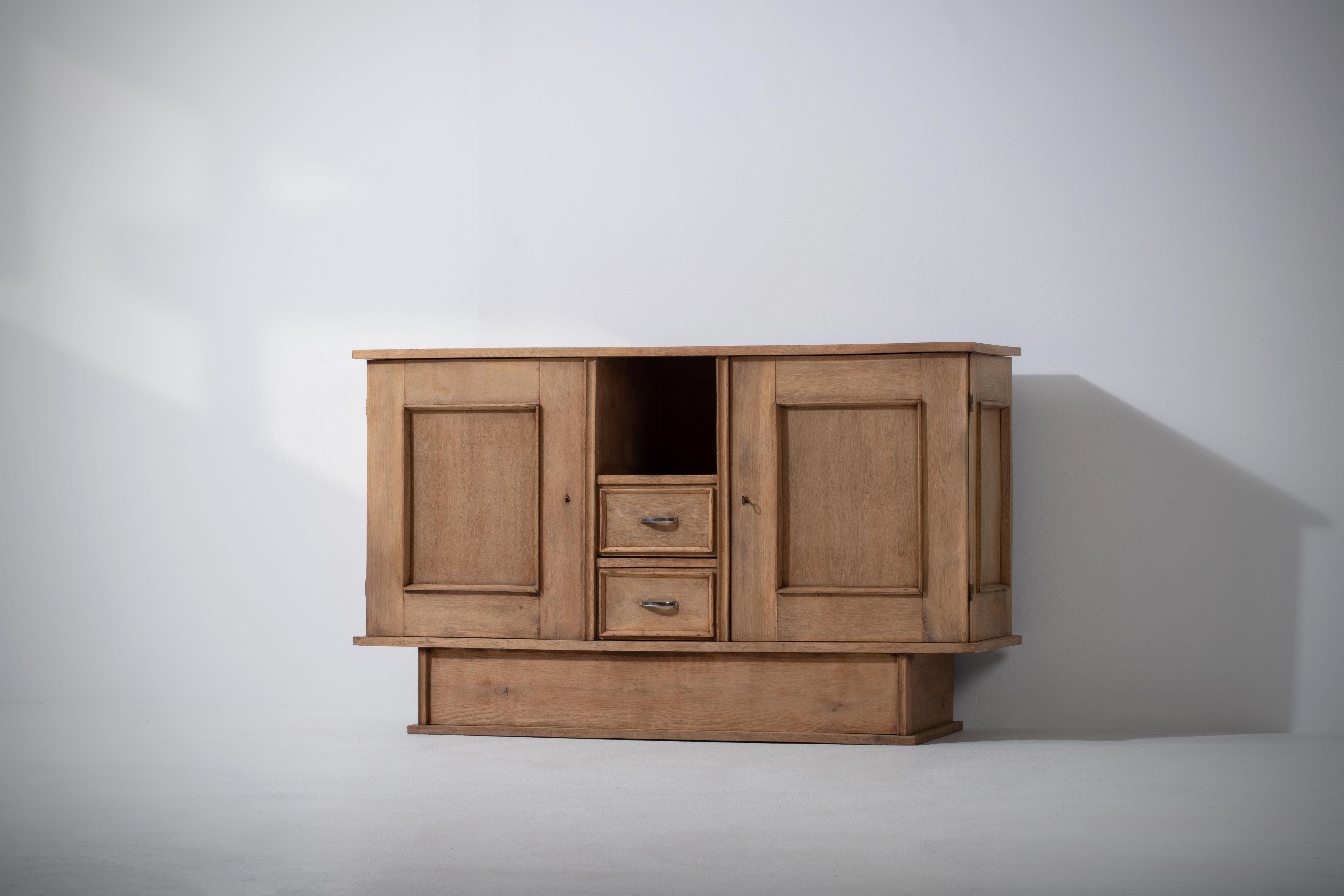 Elegant Credenza, solid oak, France, 1940s.
Nice modernist design. 
The credenza consists of two laterals storage facilities and central niche. 
Good condition.