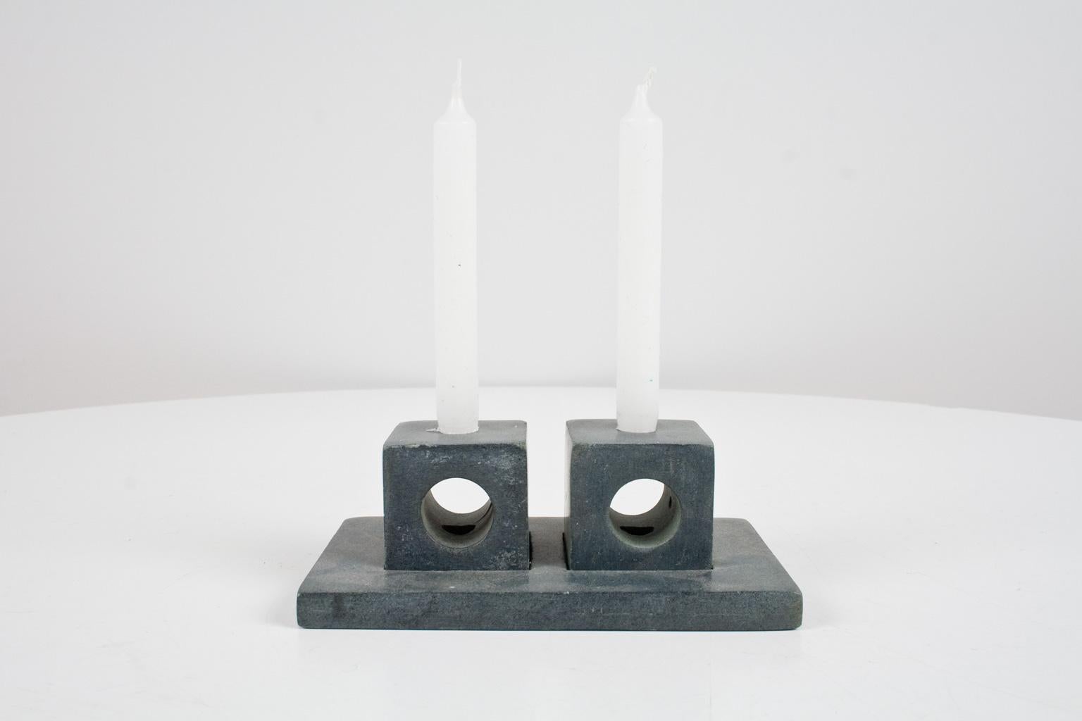 Handmade modernist bluestone candleholder, polished. Originated from Belgium, circa 1970s, designer unknown. The two cubic candleholders have three sized openings, for round candles of 19mm and of 9mm ( 0.74 and 0.35 inch) and a small size opening