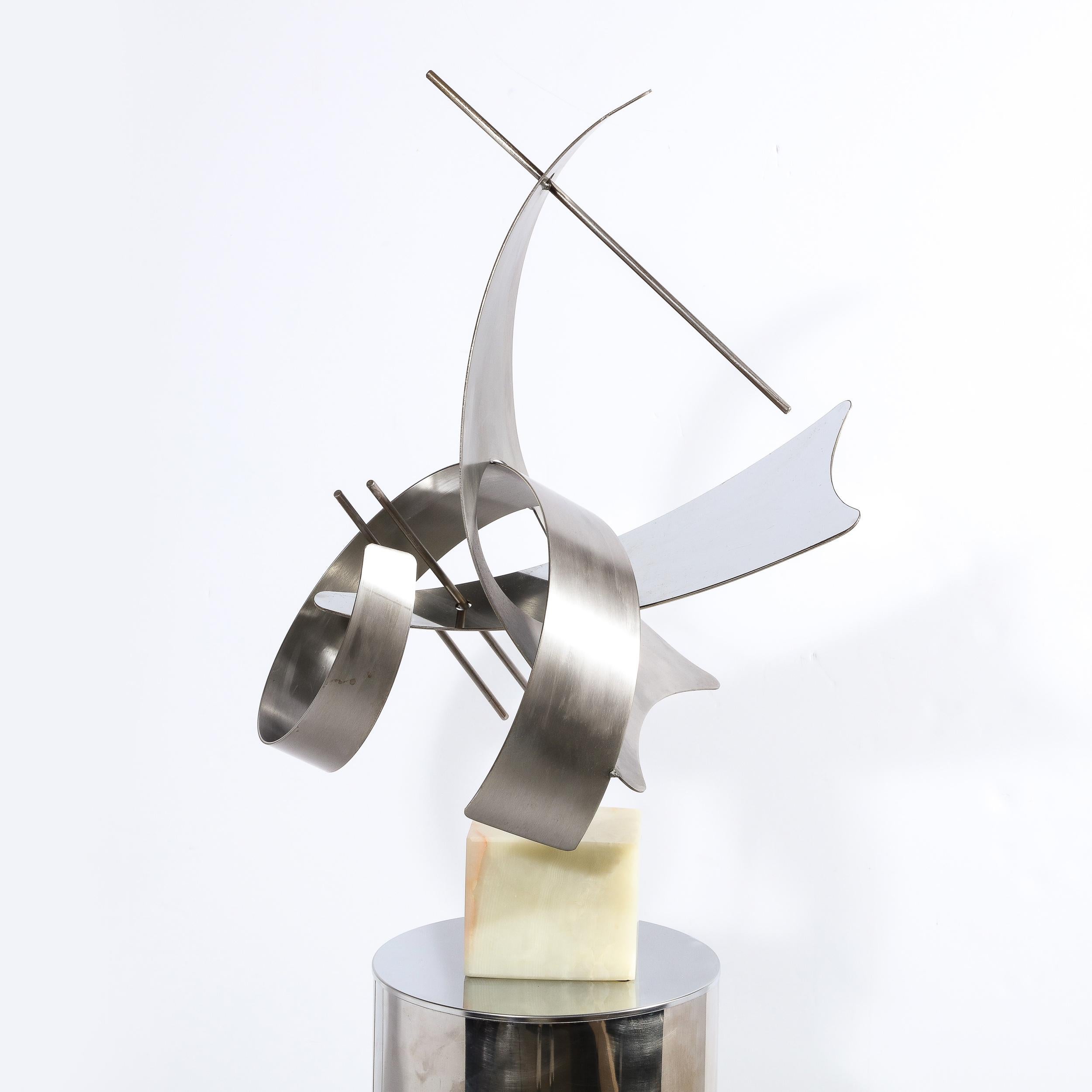 This sophisticated brushed aluminum modernist sculpture was realized in the United States in 1979. Created by an unheralded, but masterful artist, and signed Curtis J, the piece suggests a deconstructed Kandinsky painting rendered in three