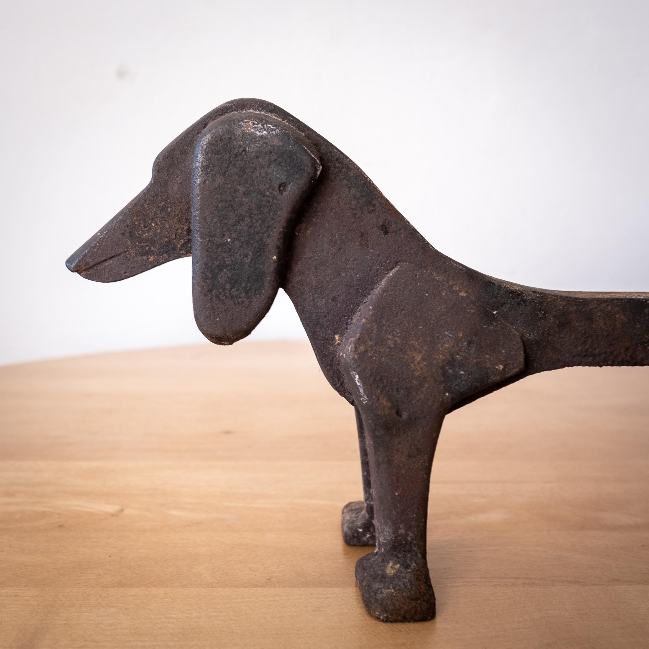 A wonderful pair of modernist Dachshund andirons. Literal fire dogs. Solid iron. 1940s.