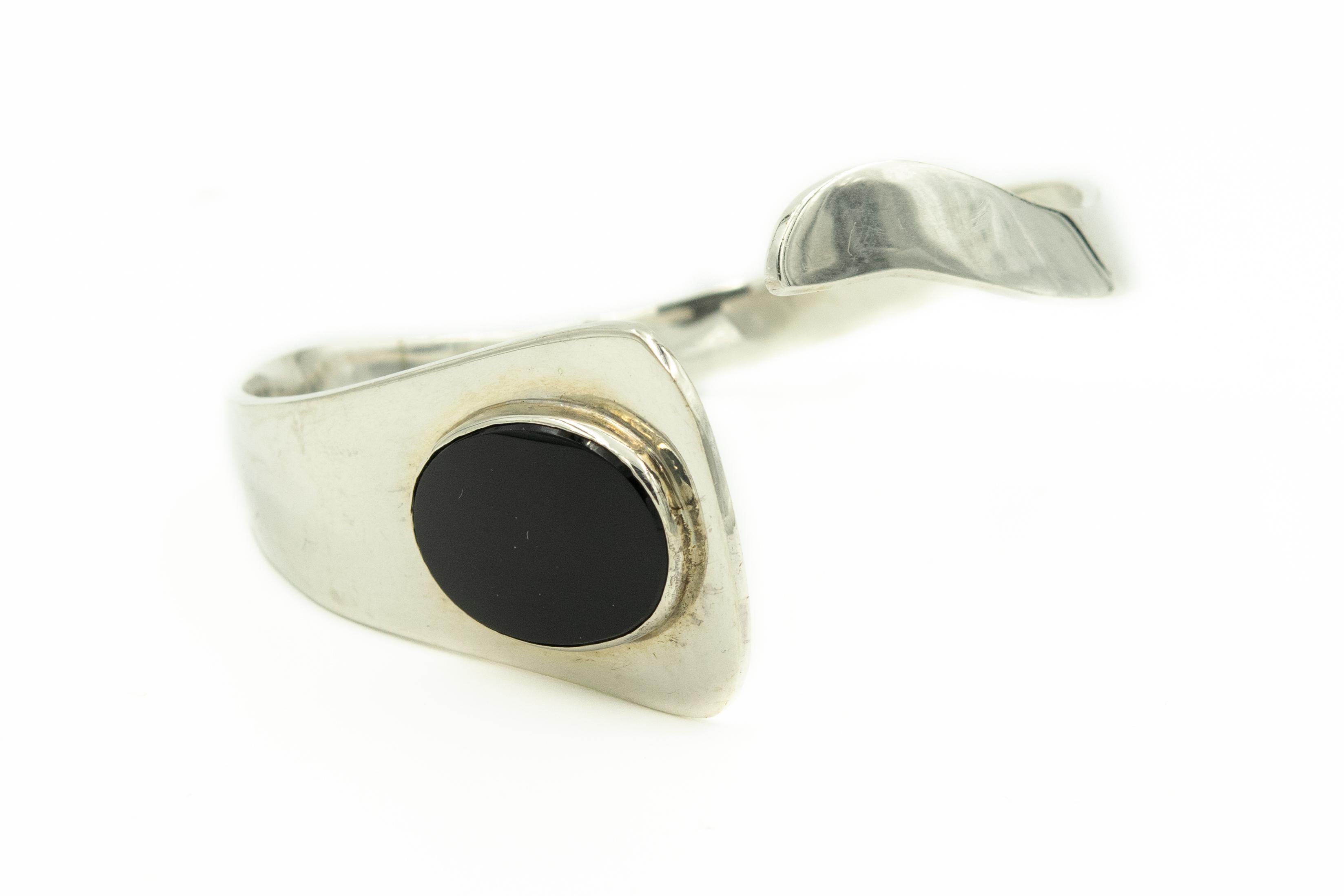 MIGHT HAVE REPAIR ON BRACELET

This stunning bracelet was designed by Andreas Mikkelsen a silversmith who worked at Georg Jensen.  The bracelet has an oval shaped flat onyx accent piece.
Bracelet measures 2.5