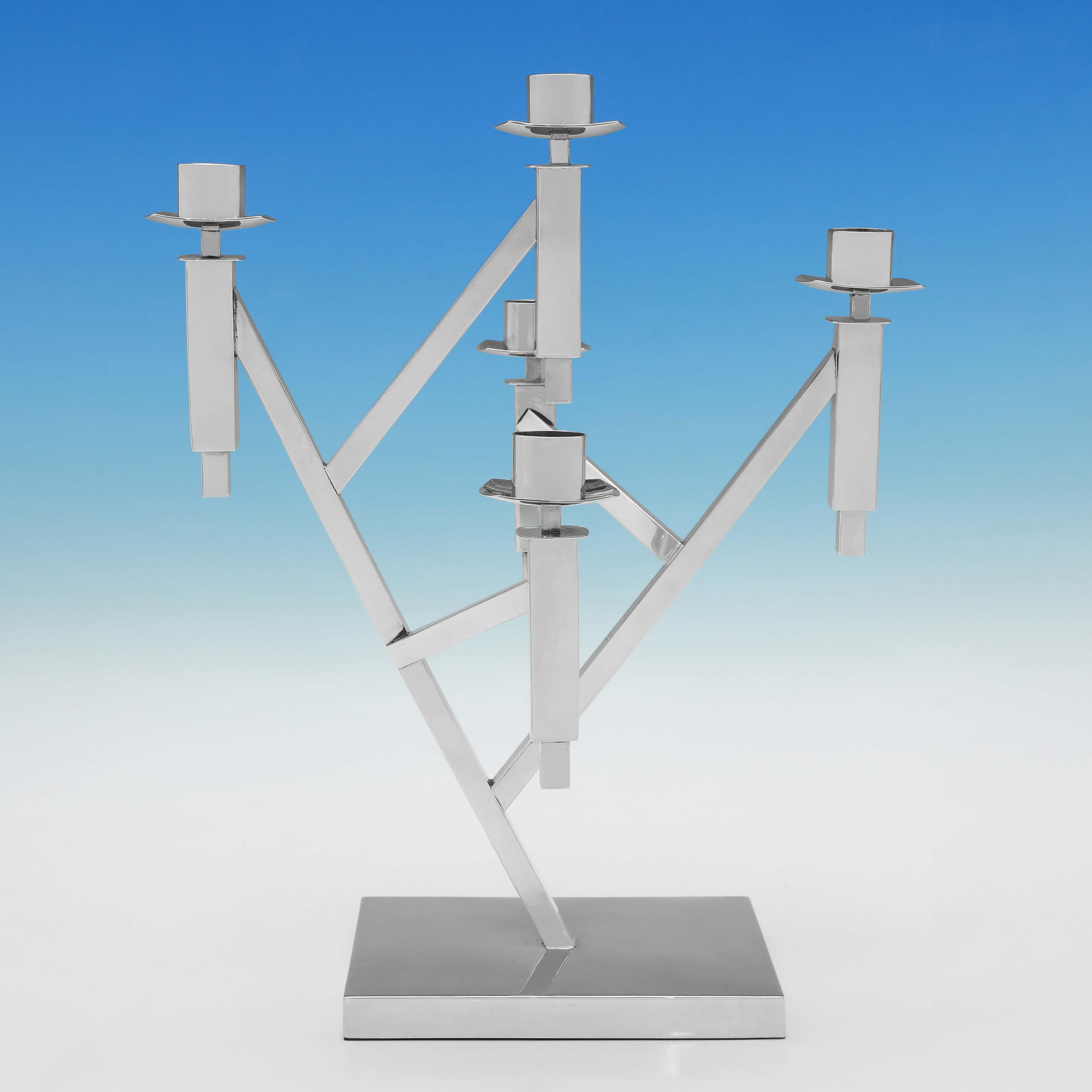 Siglato a Birmingham nel 2000 da T. Stocks, questo candelabro in argento sterling dal design modernista può contenere 5 candele di diverse altezze e sarebbe un fantastico centrotavola per una casa moderna. 

Il candelabro misura 13