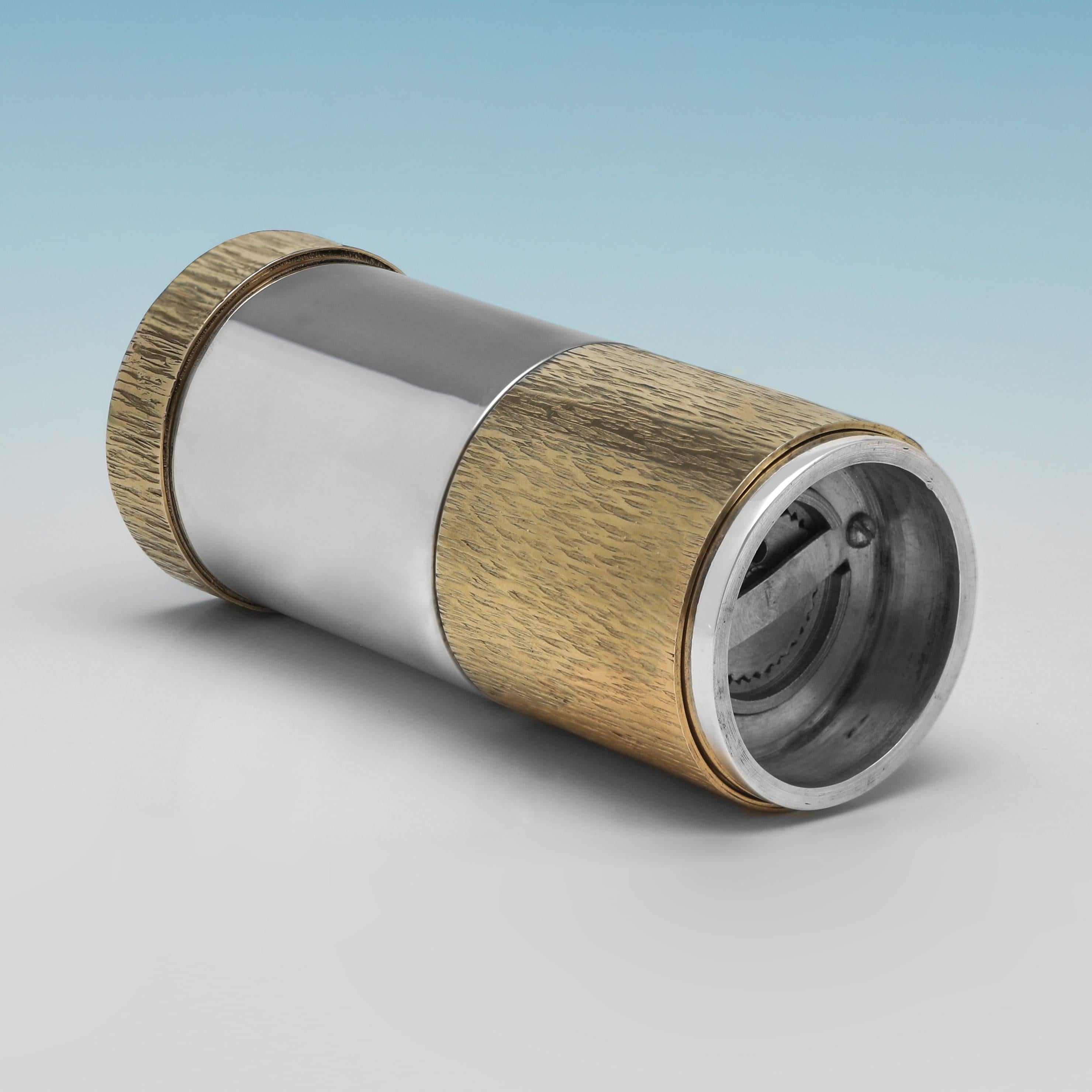 Hallmarked in London in 1971 by Mappin & Webb, this handsome, Elizabeth II period, Sterling Silver Pepper Grinder, features partial gilt bark effect decoration. The pepper grinder measures 4.25