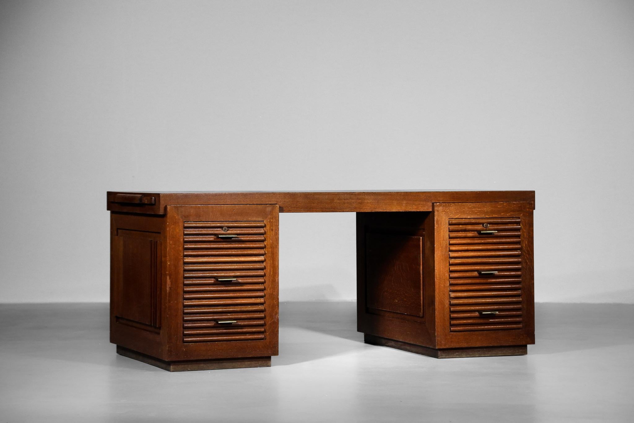 Rare modernist desk designed by Charles Dudouyt.
Composed with 2 cases on each side with 3 drawers and bronze handle. 
Made of massive oak. We also provide one original key.
Really nice quality work.