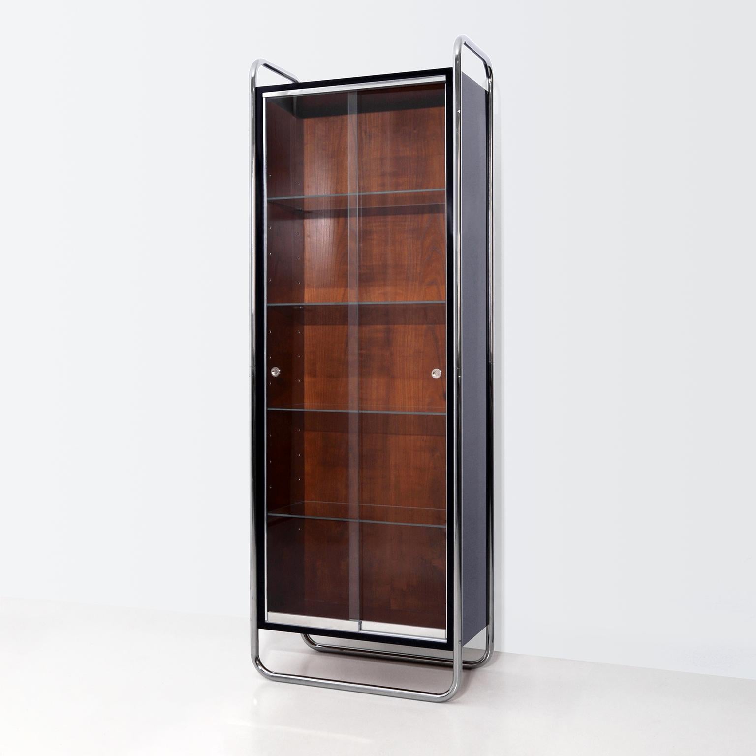Vitrine moderniste, acier tubulaire chromé, blockboard laqué et plaqué cerisier, personnalisable.
Délai de production : environ 10 semaines.