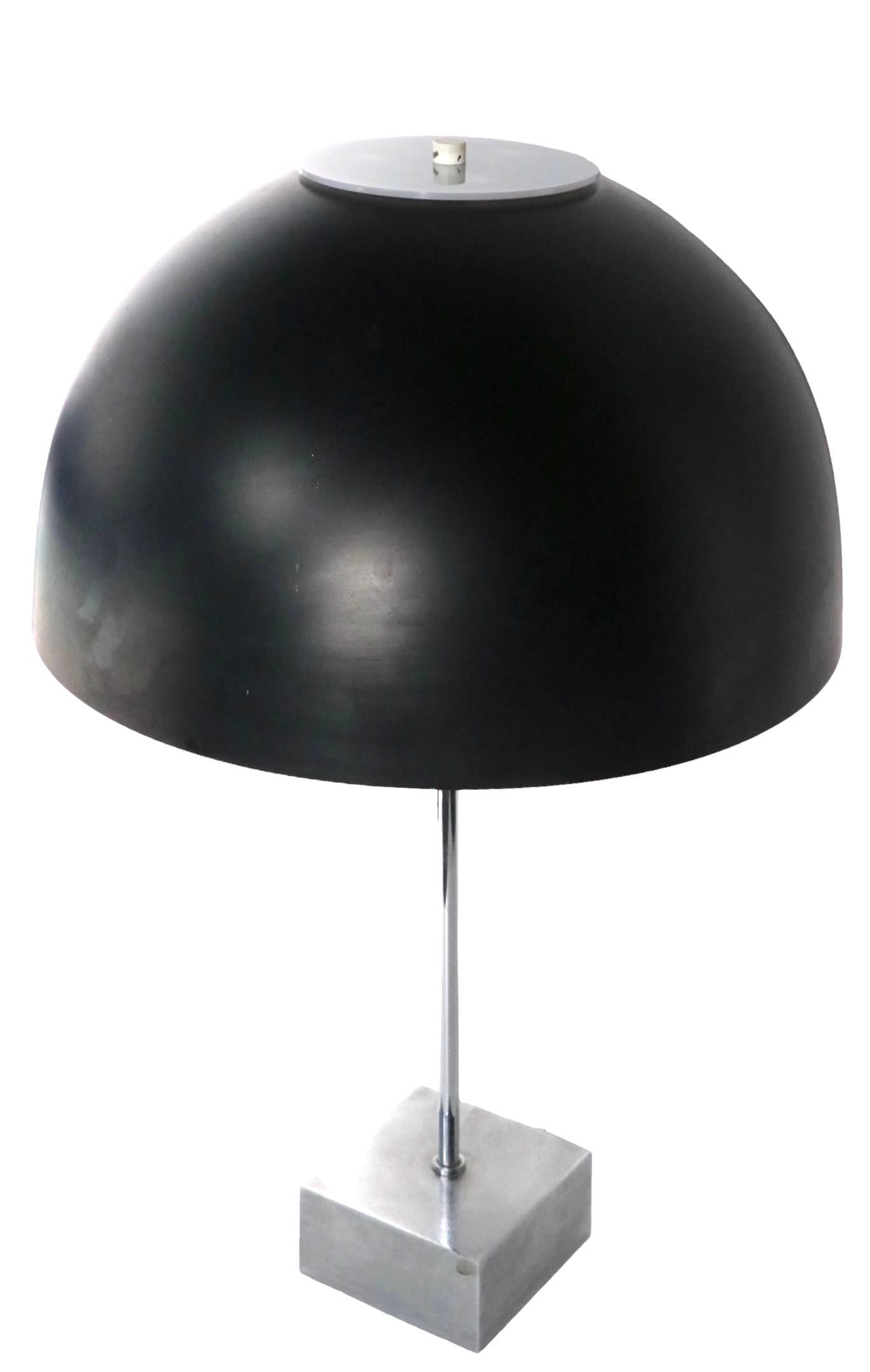 Classic Mod design table lamp designed by Paul Mayer for Habitat. The lamp features a black dome shade with a chrome base. The lamp accepts two standard size screw in bulbs, and still retains it’s original Habitat label at the top sockets. This