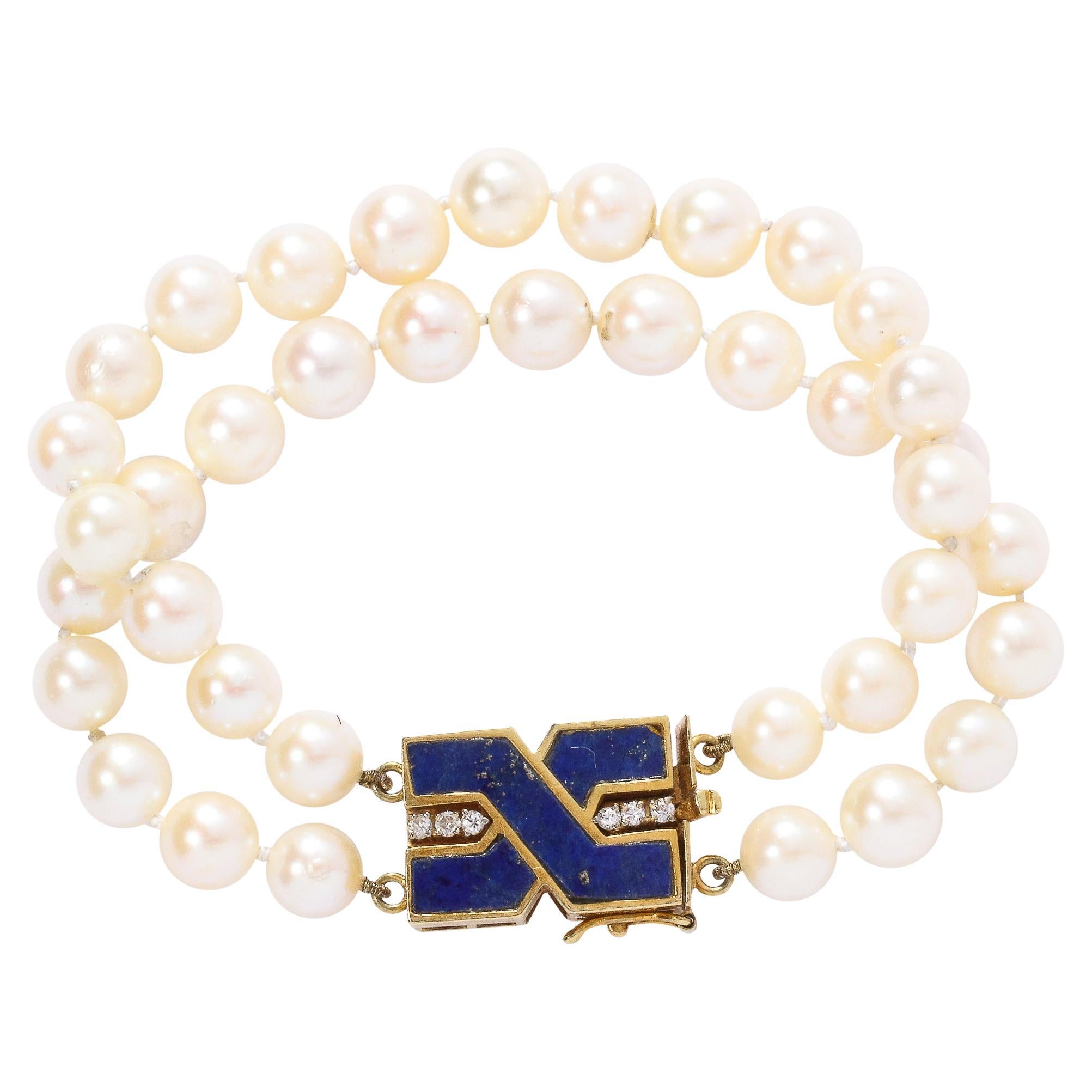 This very sophisticated double strand pearl bracelet are fitted with 38 fine pearls of approximately 7 mm each in a lovely rose luster. It is secured with a 18k yellow gold ,lapis lazuli and diamond clasp. The bold modernist geometric design for the