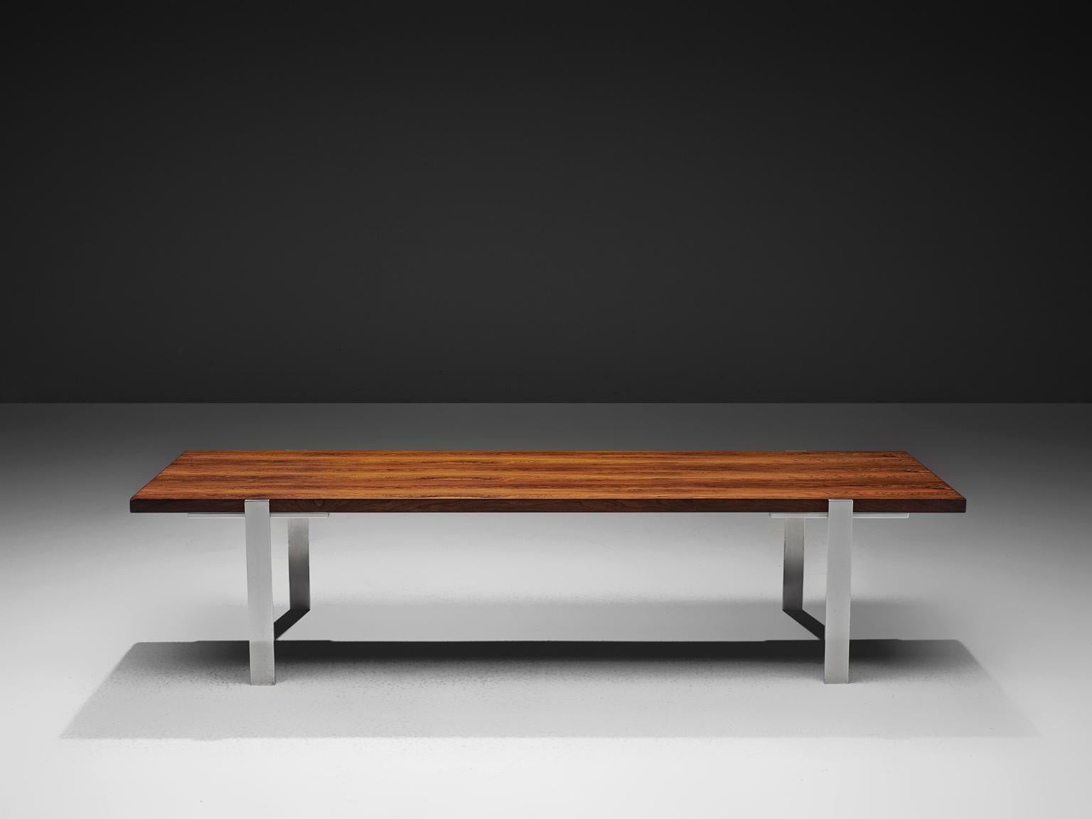 Coffee table, rosewood and stainless steel, the Netherlands, 1960s.

The rectangular top is made with rosewood veneer slats, in wonderful different tones. The warm expression of the basic top beautifully contrasts to the thin straight steel legs.