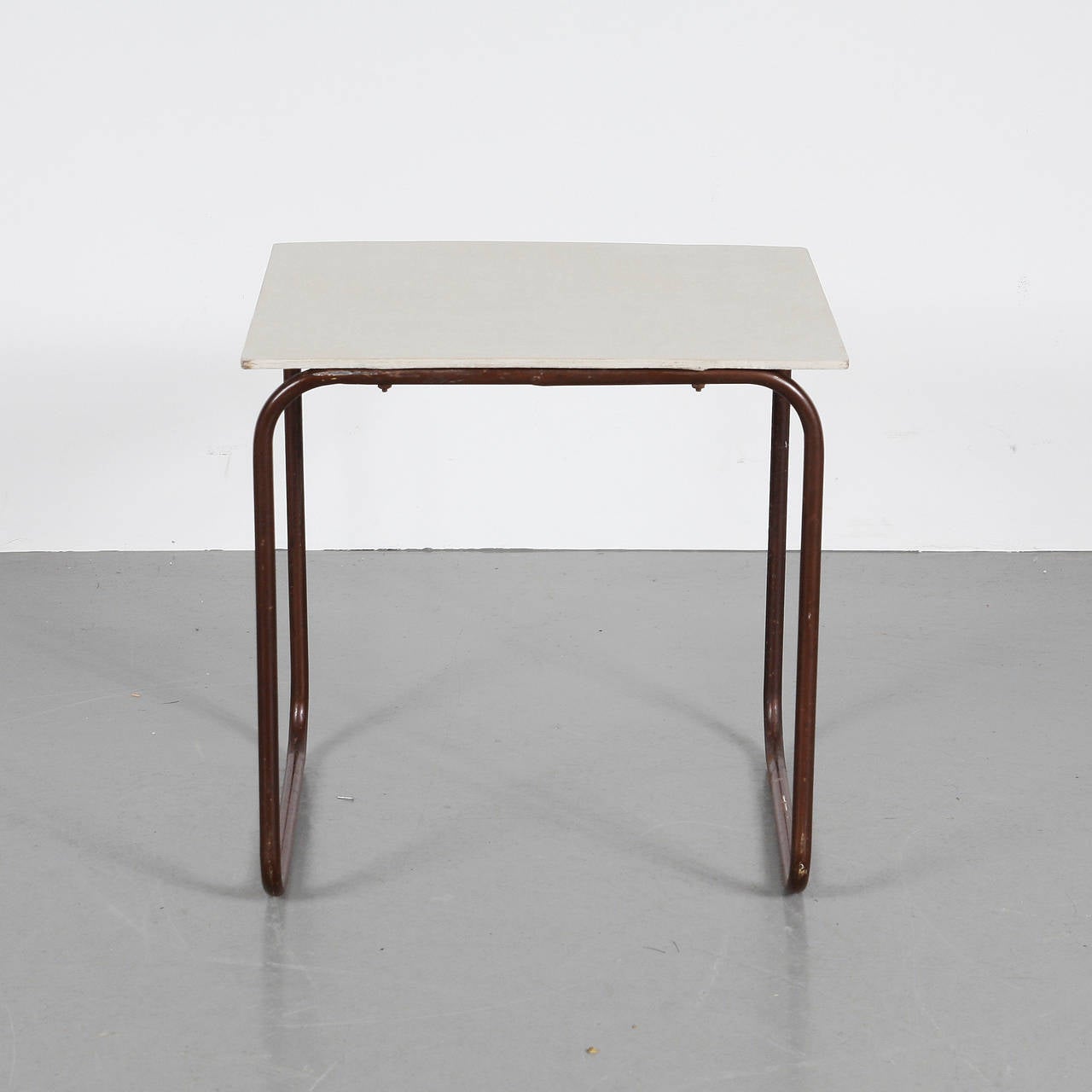 Side table manufactured in the Netherlands, circa 1950.
Lacquered wood top in original condition with tubular metal frame.
 
  