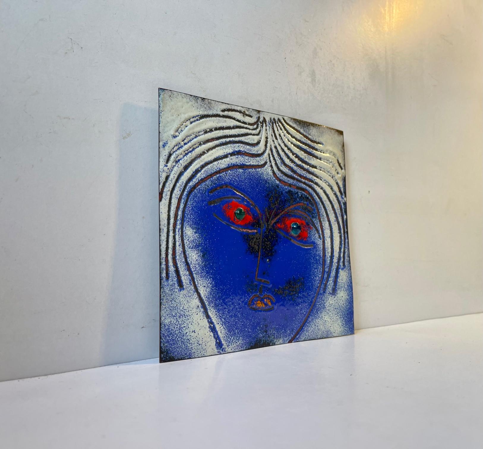 Piece unique - art wall plaque executed in vibrant colored enamel on copper. Blue eyes made from glass. It was made by the Danish Brutalist Jewelry designer and artist Jacob Hull in his own studio in Denmark during the 1970s. This work by Hull